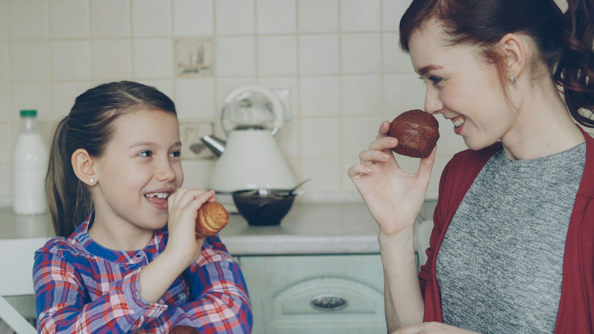 Mother and daughter enjoy breakfast together.