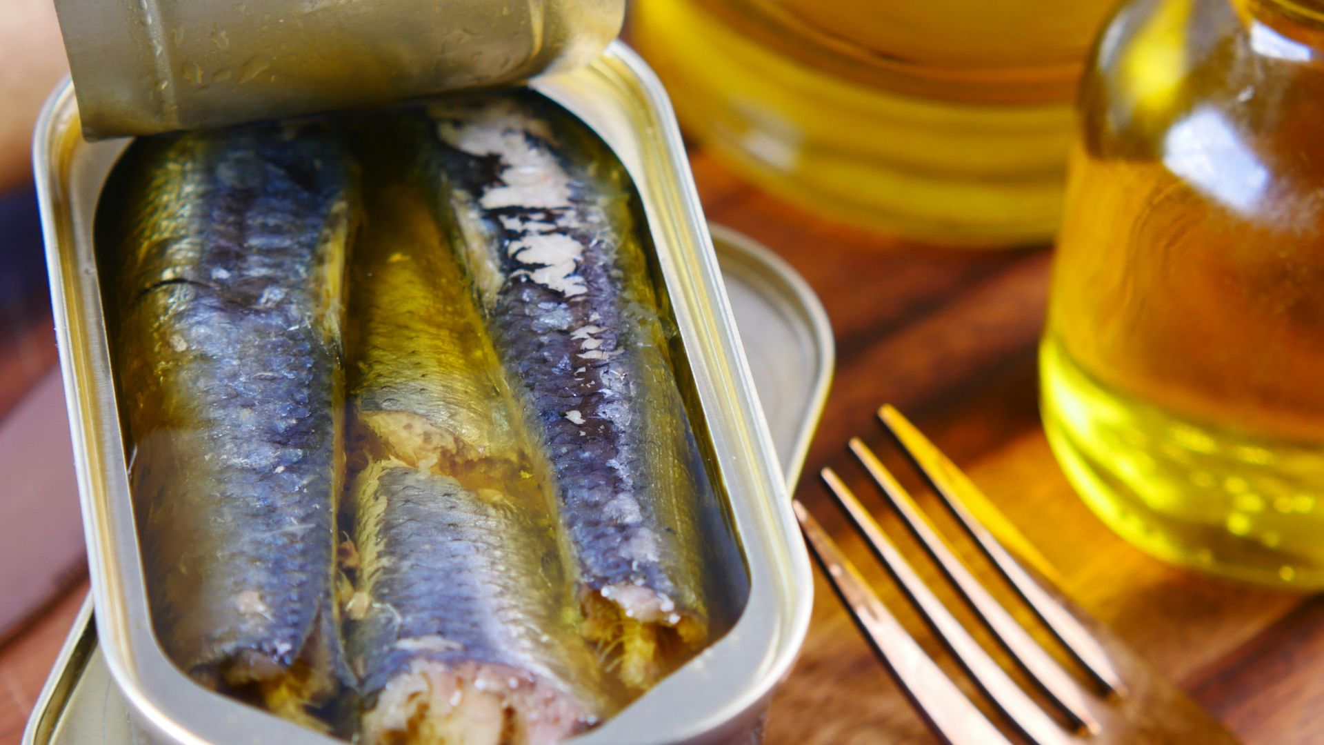 a tin of sardines sitting on top of a wooden table