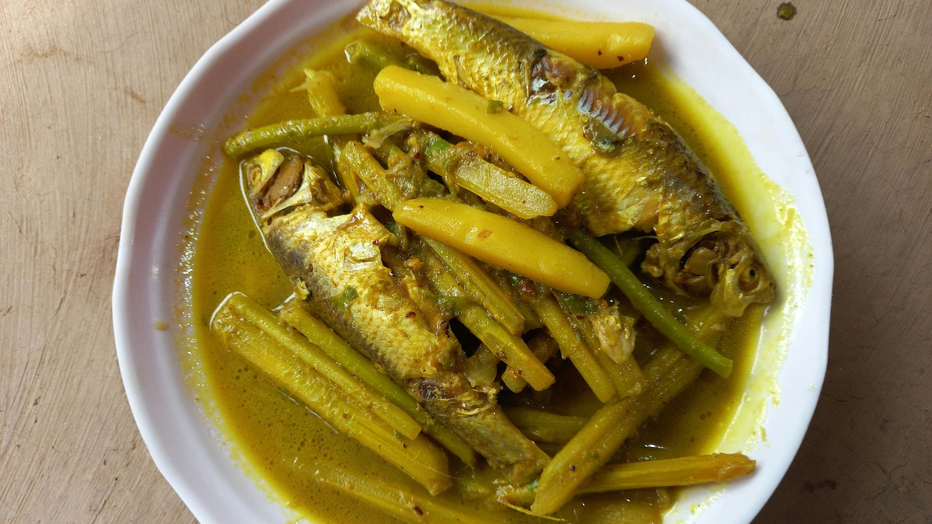 A white bowl filled with fish and green beans