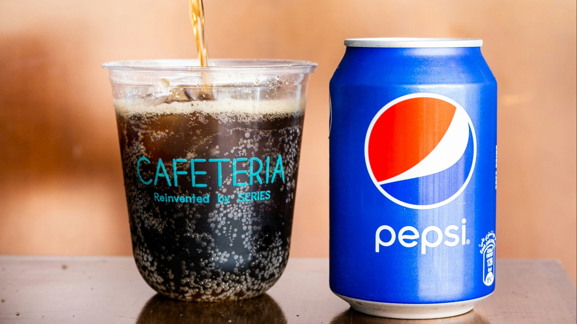 person pouring cup with Pepso soda