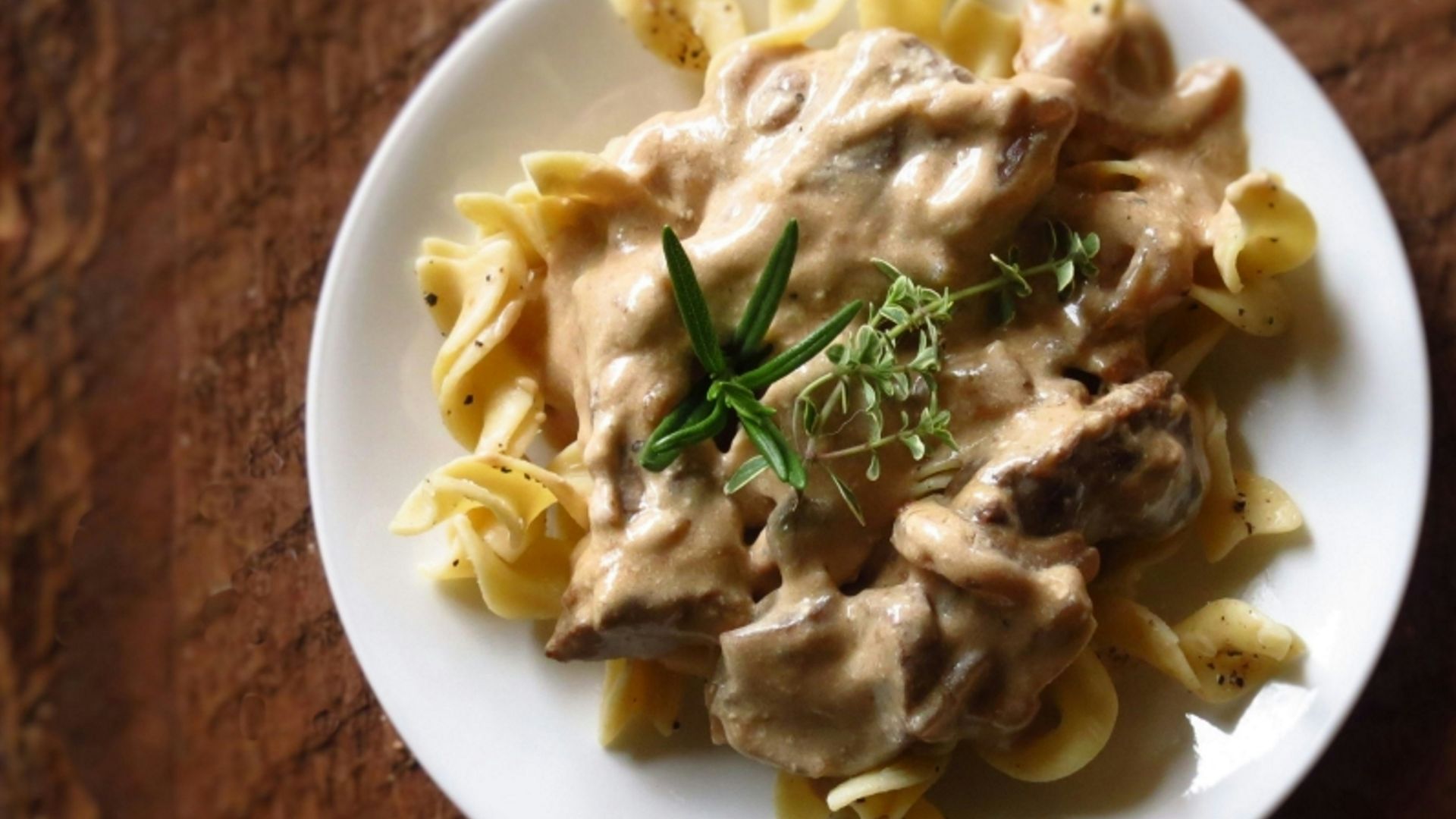 a white plate topped with pasta covered in sauce