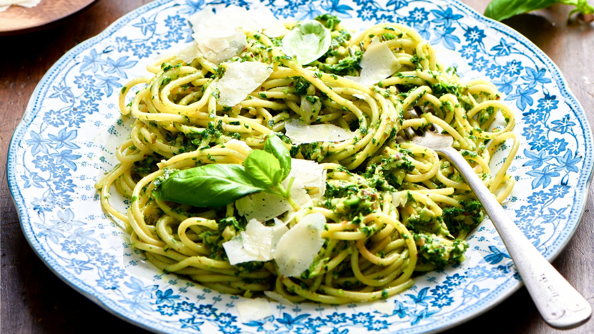a plate of pasta with broccoli and parmesan cheese