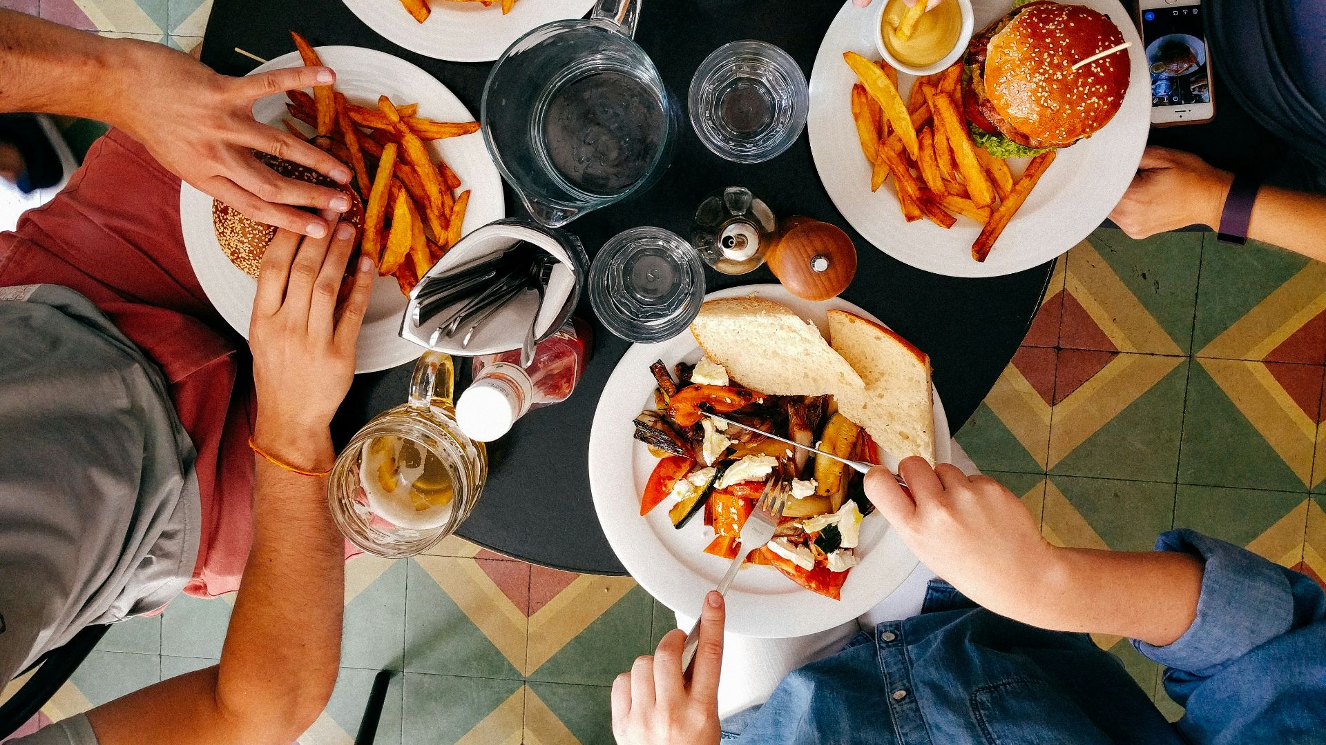 four person earring on black wooden table