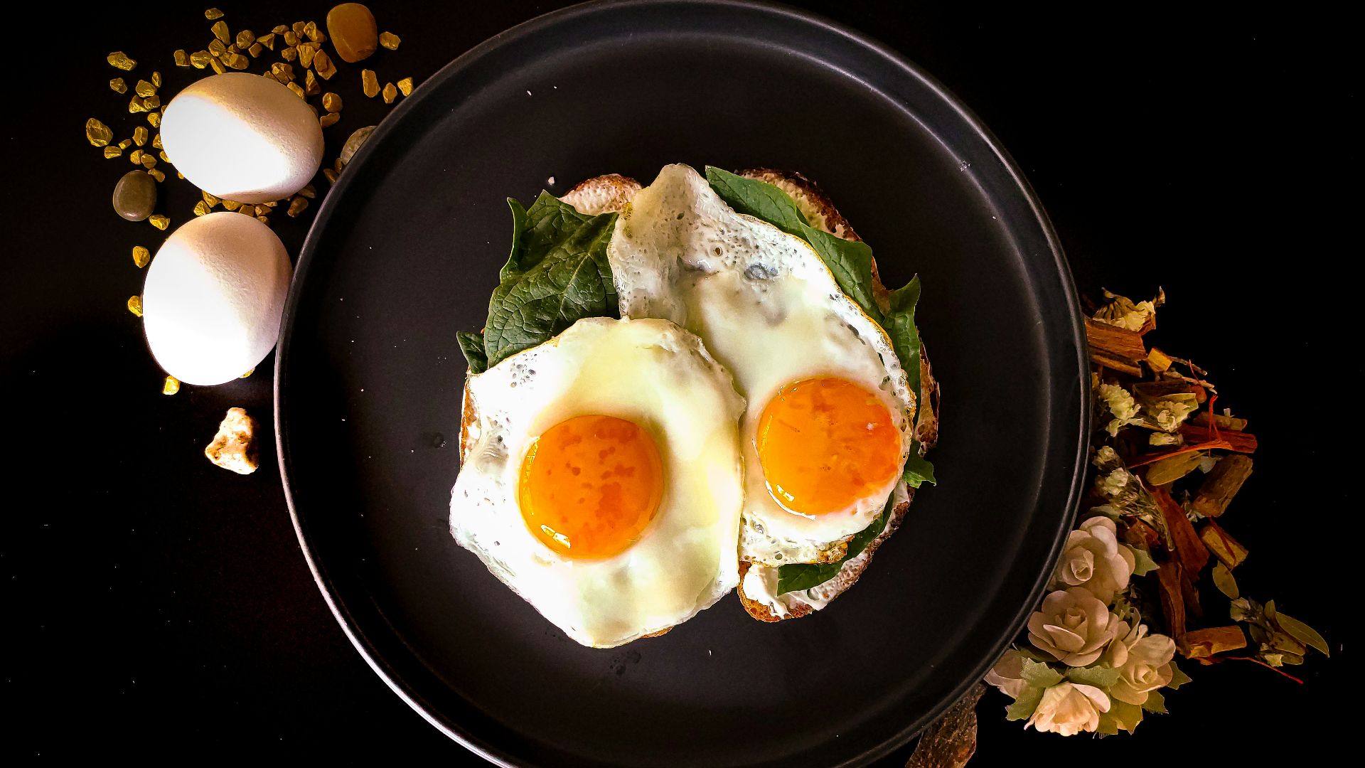 sunny side up egg on black ceramic plate