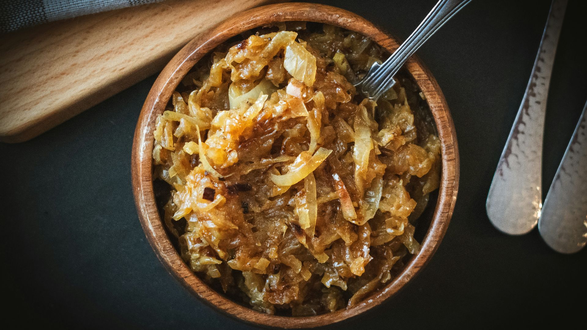 a bowl of food with a spoon next to it