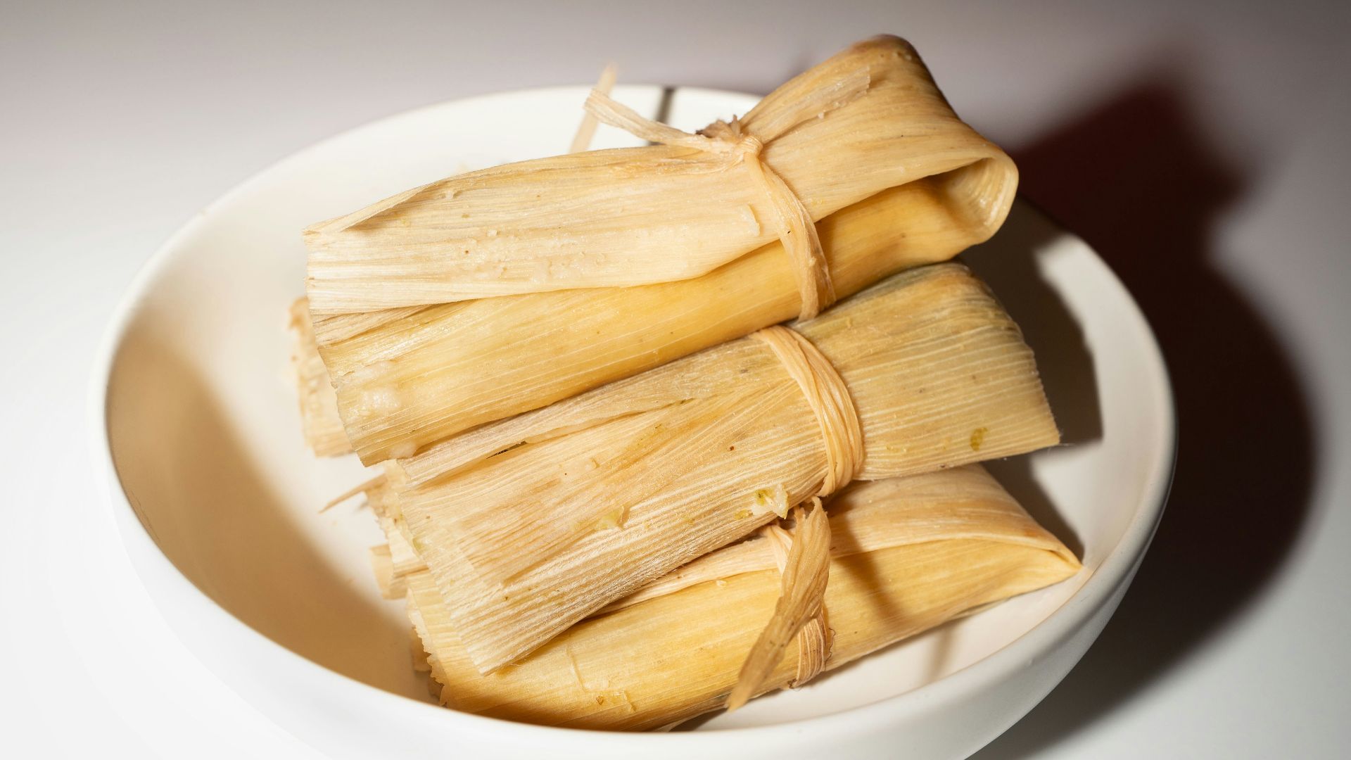 A white bowl filled with food on top of a table