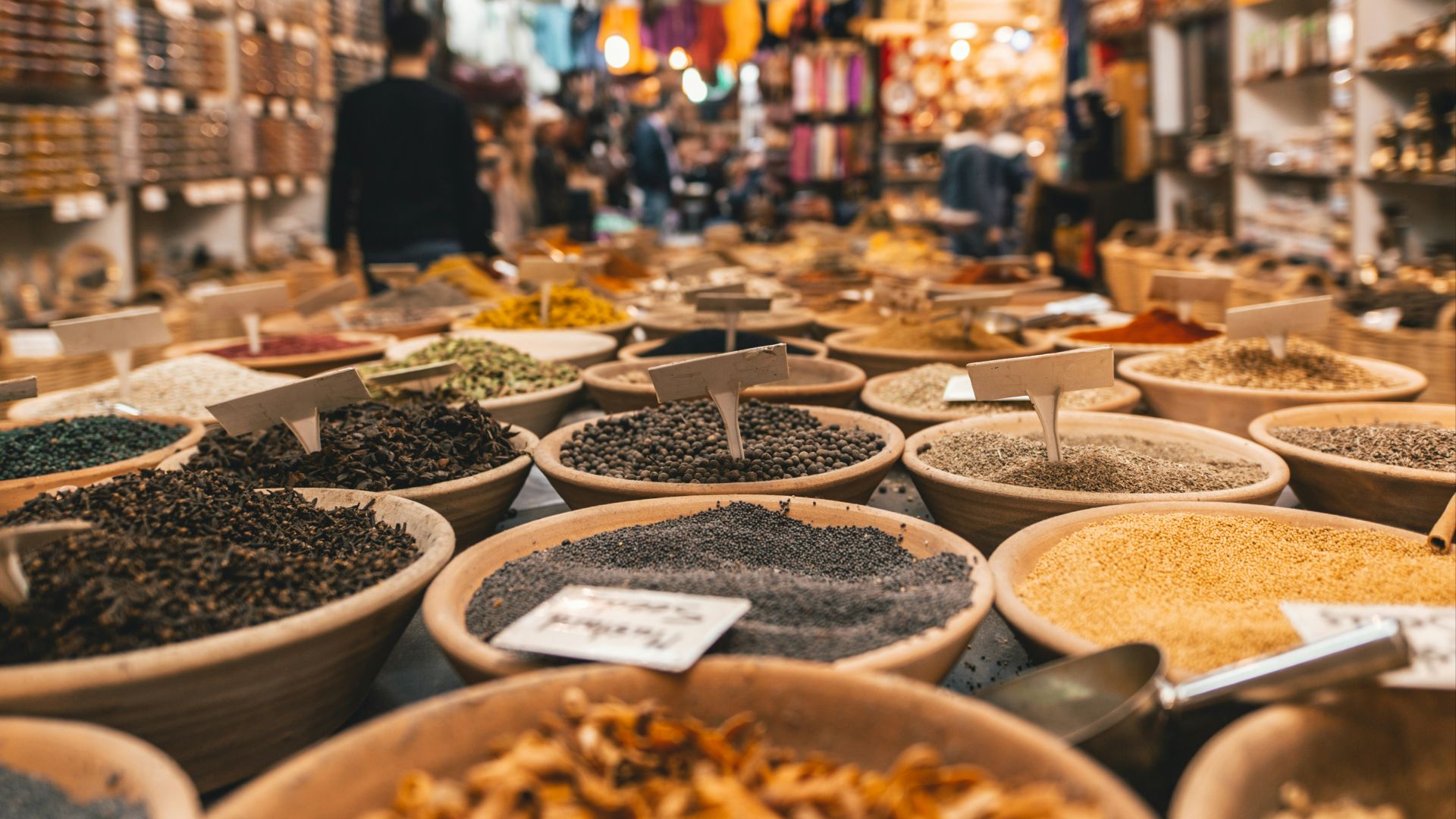 people walking beside pot of grains