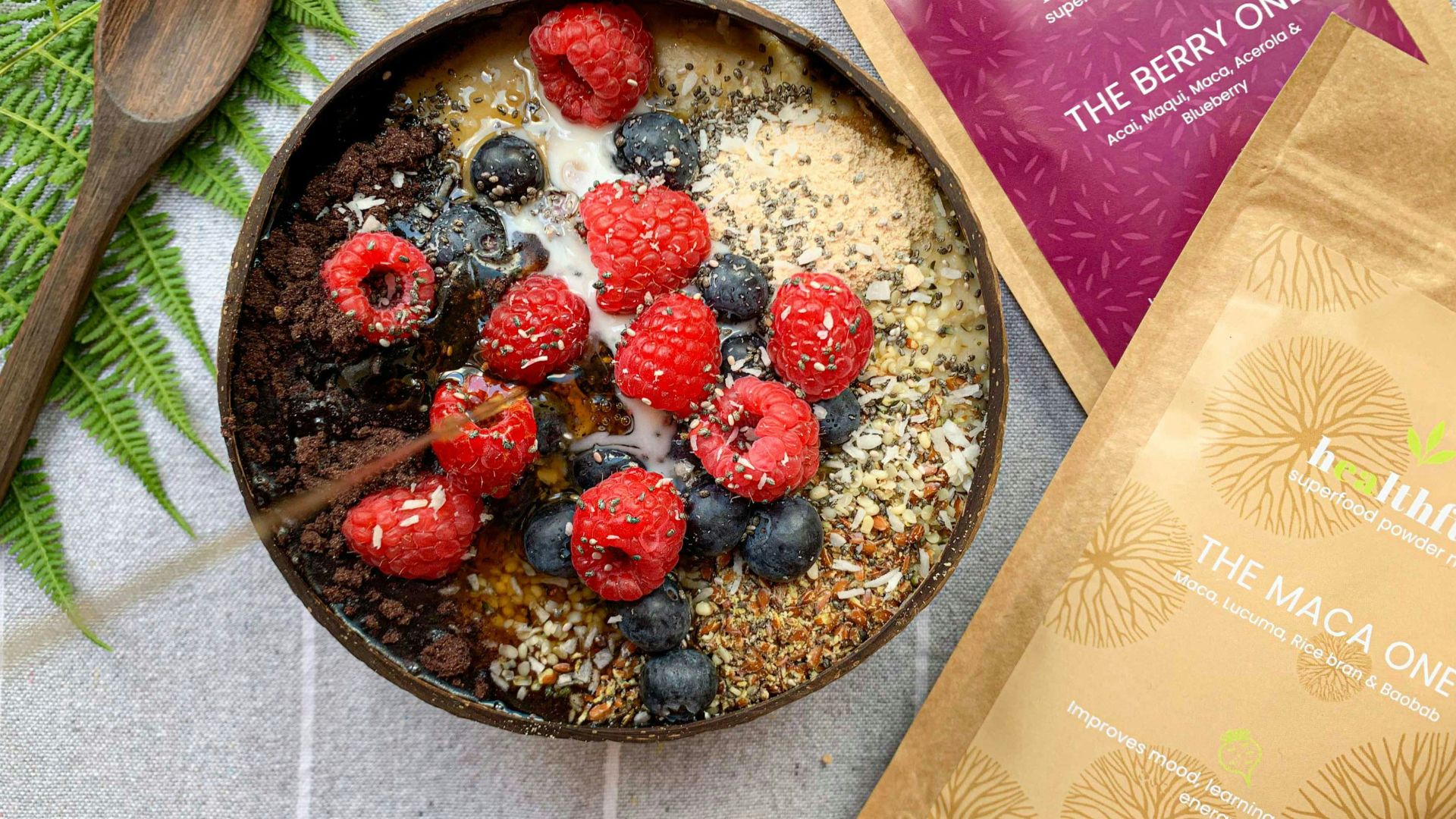 a bowl of oatmeal with raspberries and blueberries