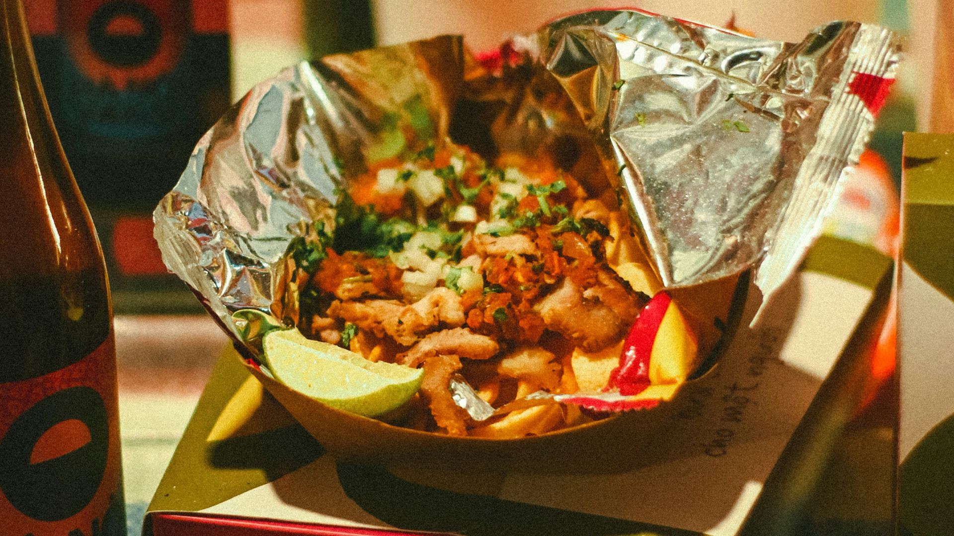 a plate of food sitting on top of a table next to a bottle of beer
