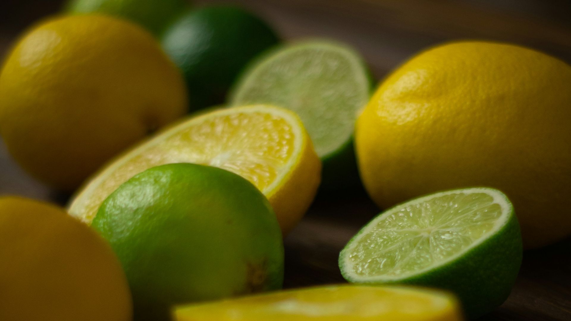 a group of lemons and limes on a table