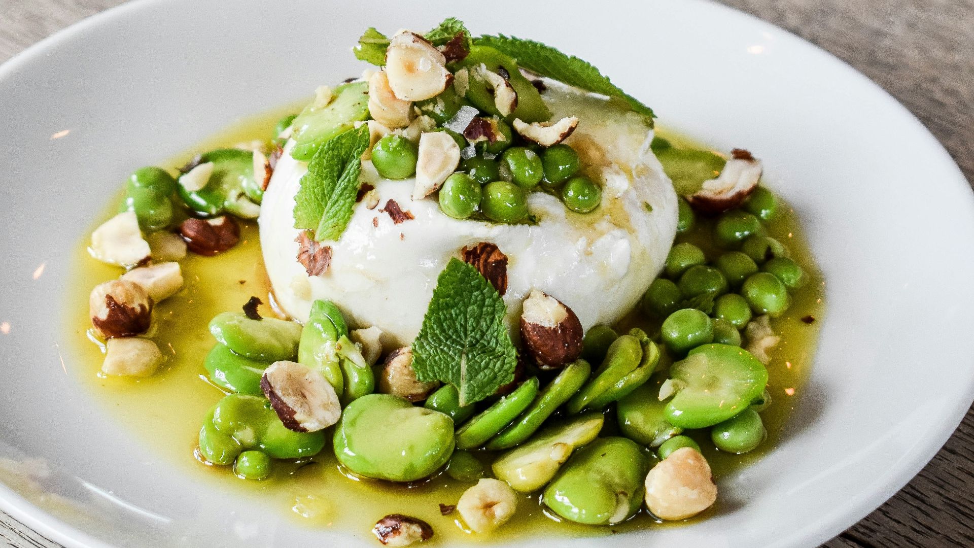 a white plate topped with a scoop of ice cream