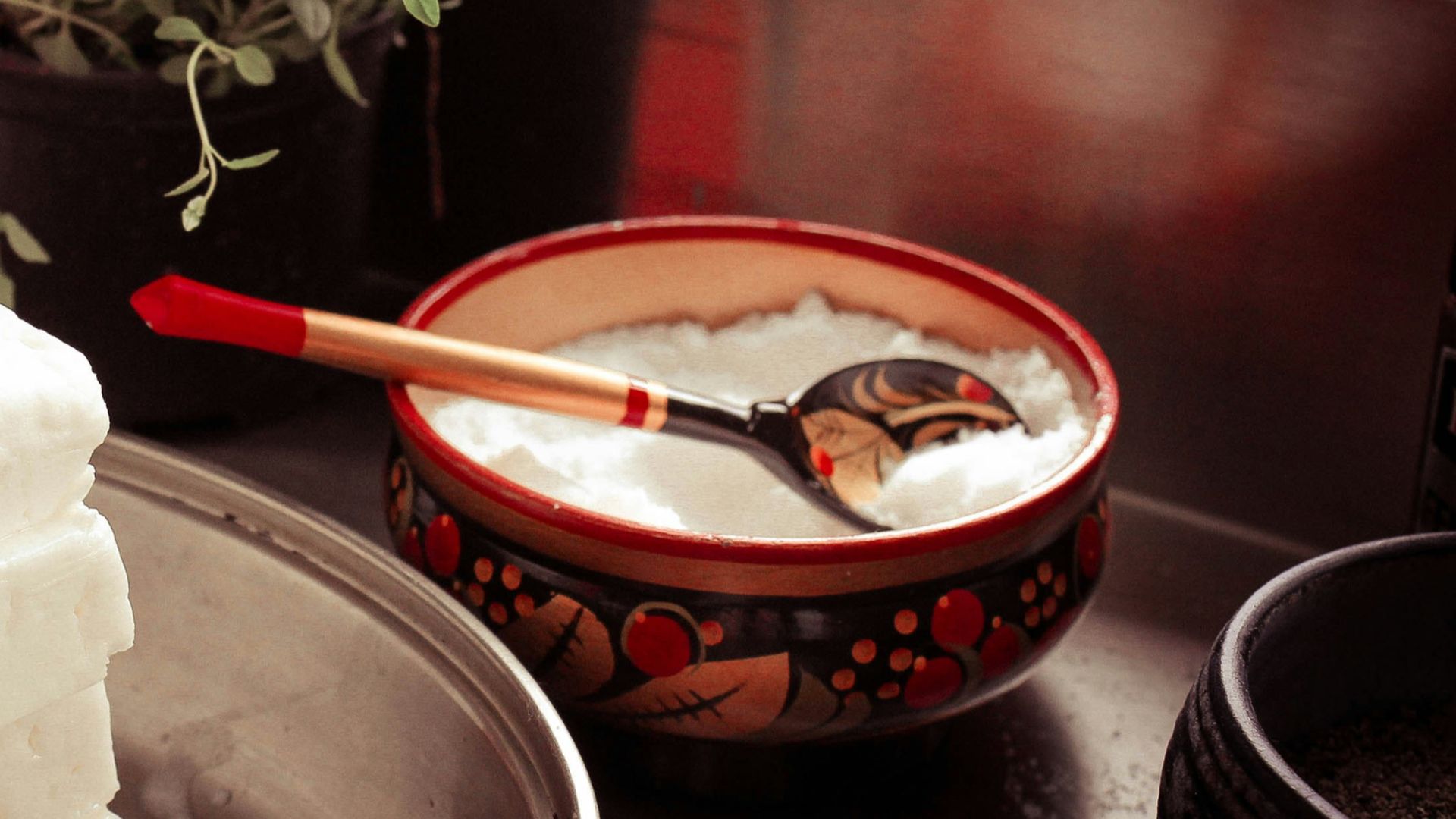 red ceramic bowl on gray spoon