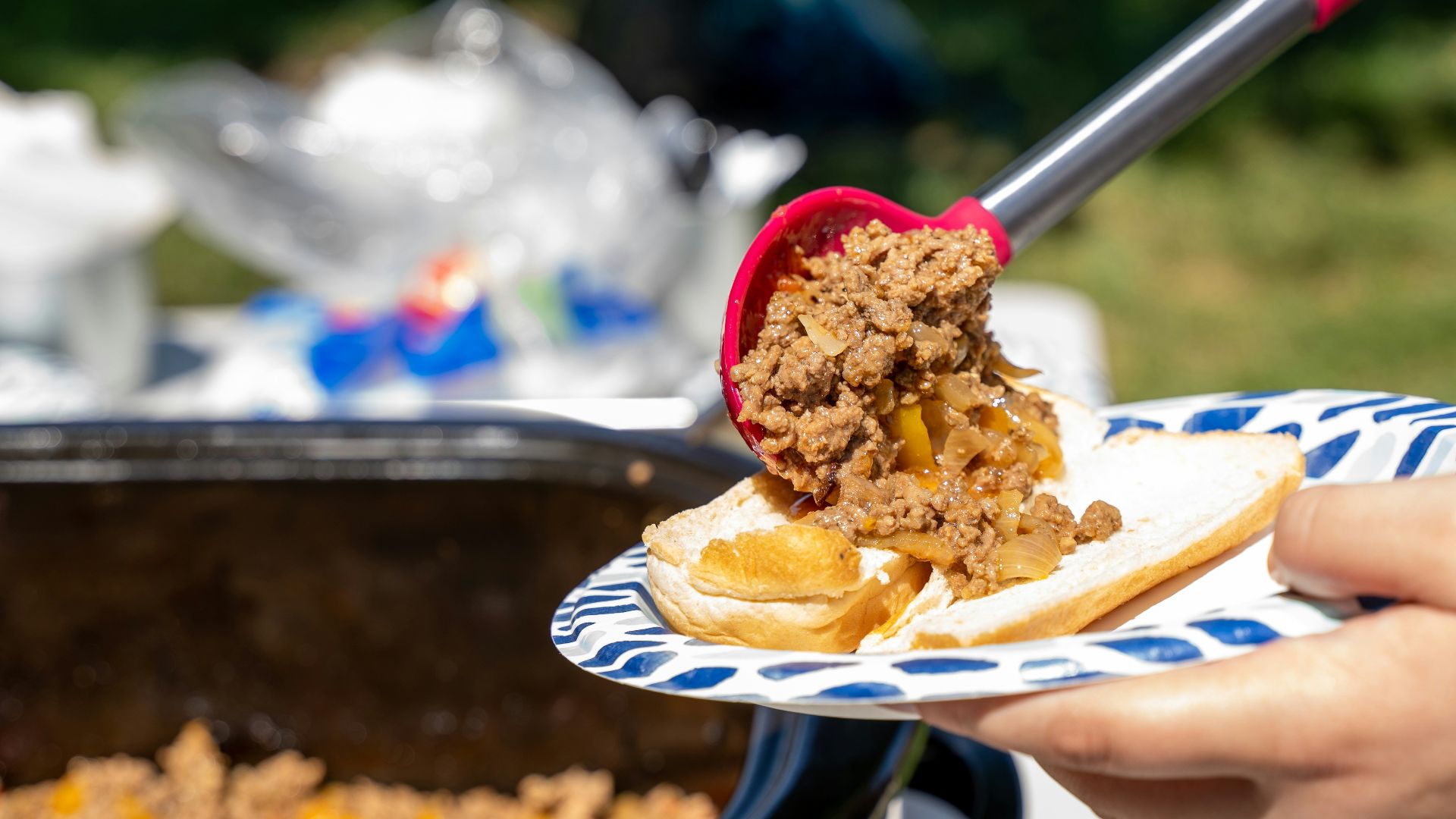 a person cutting a cake with a knife