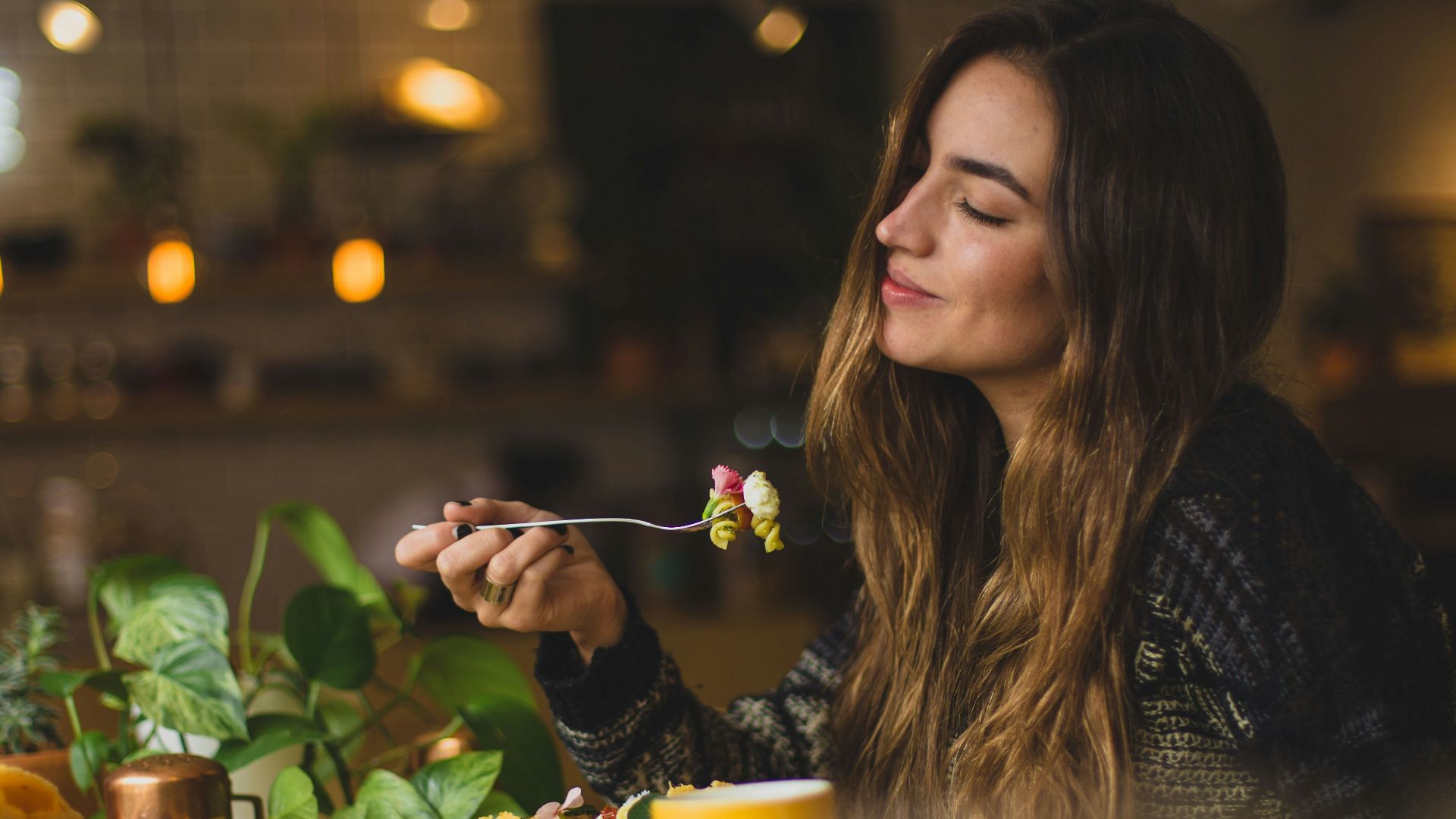 woman holding fork in front table