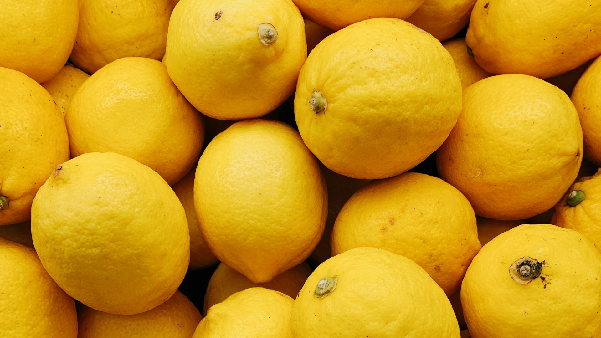 yellow citrus fruits on black surface