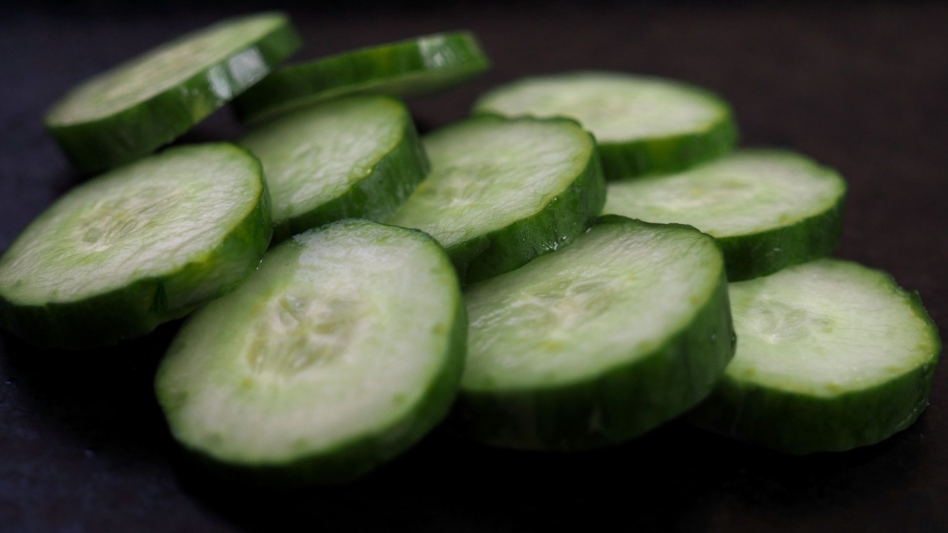 sliced cucumber on brown wooden table