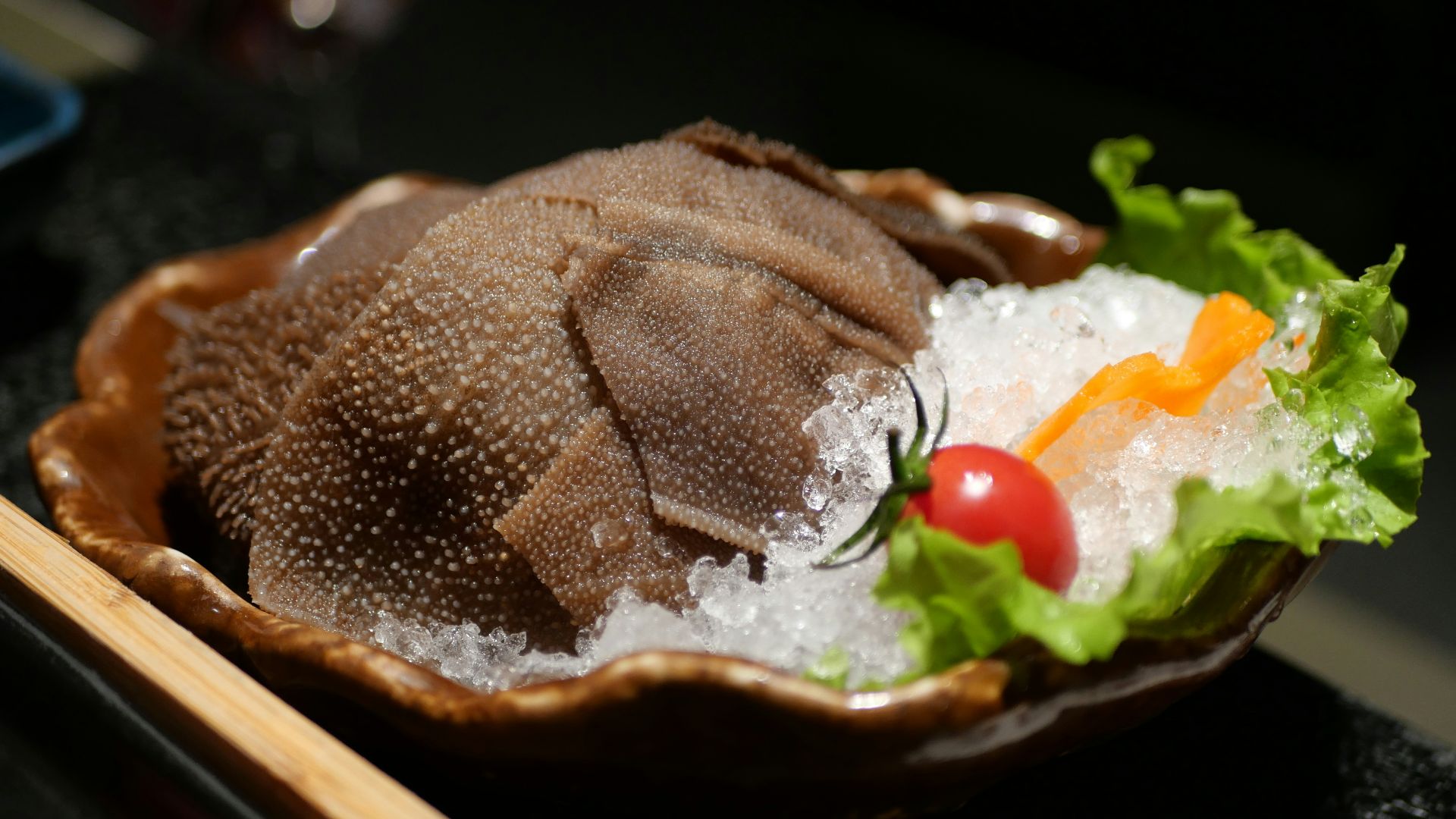 A bowl of food on a table with chopsticks