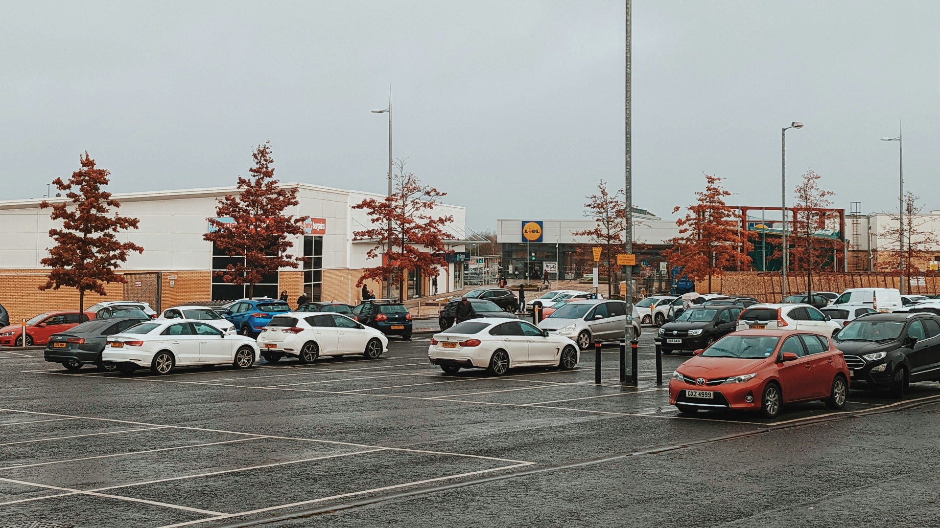 a parking lot filled with lots of parked cars