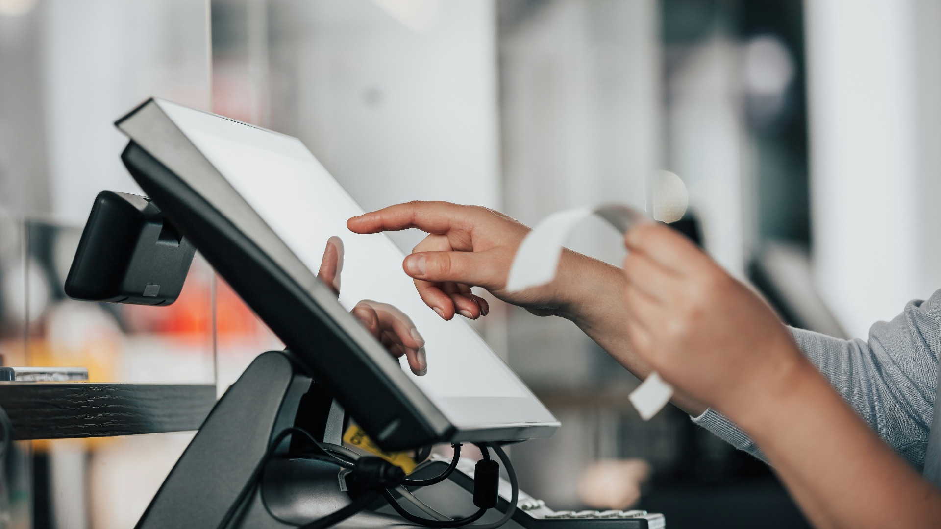 a person is using a pos machine in a store