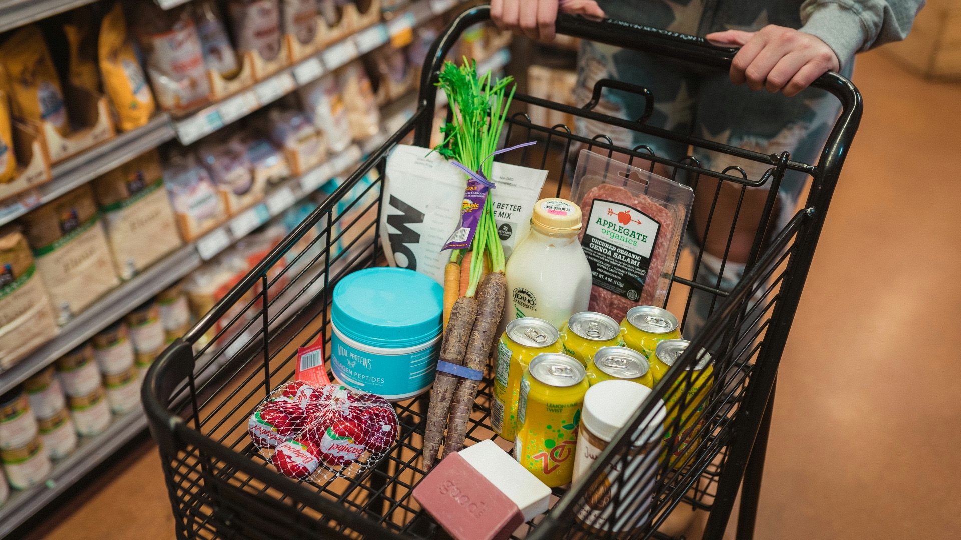 a person pushing a shopping cart full of food