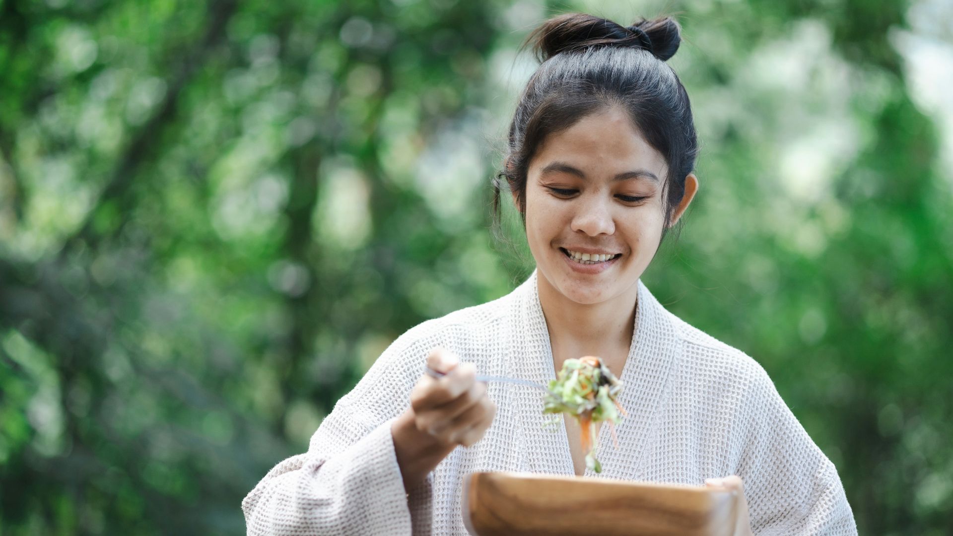a woman in a kimono holding a plate of food