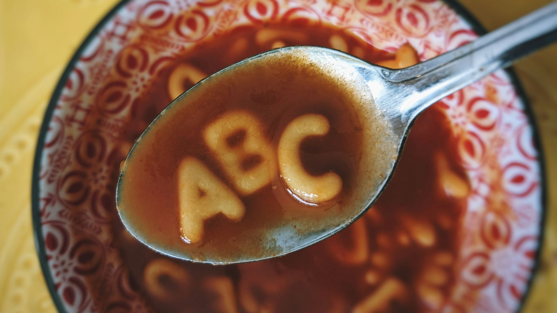 red and white ceramic bowl with silver spoon