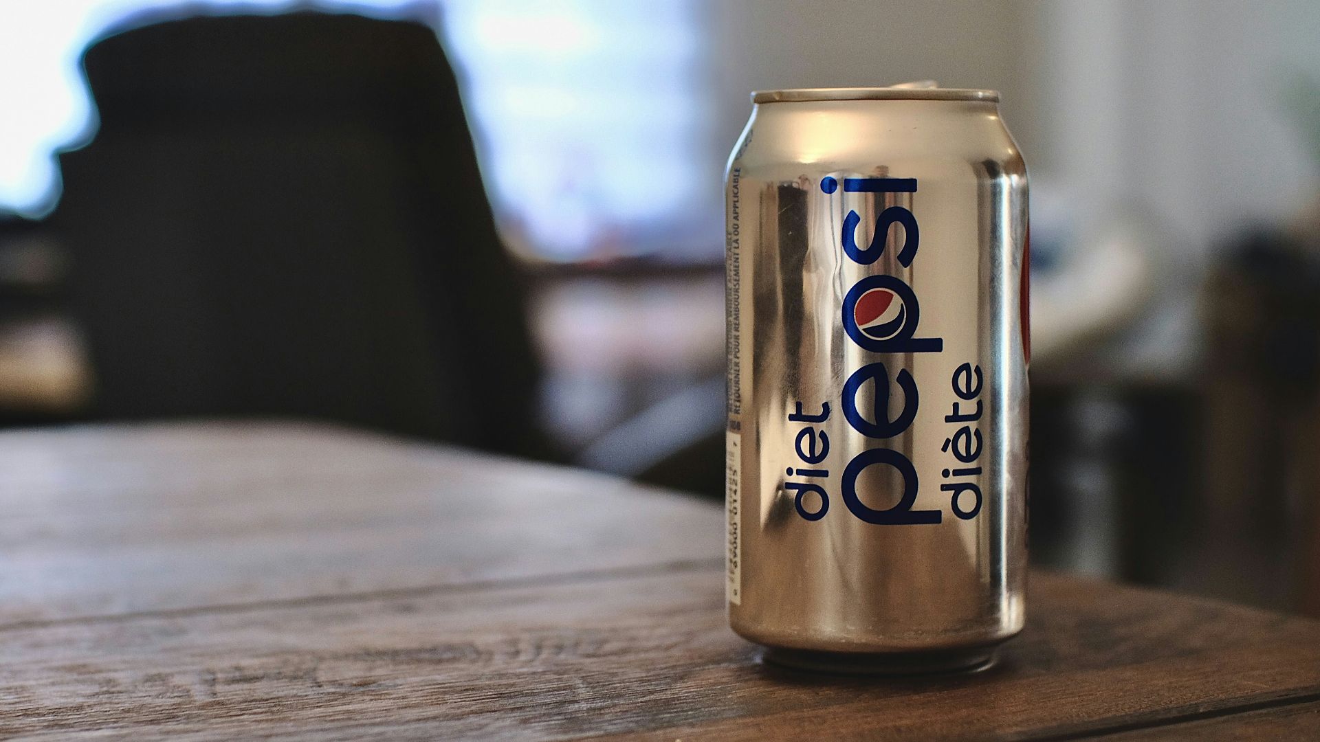 diet coke can on brown wooden table