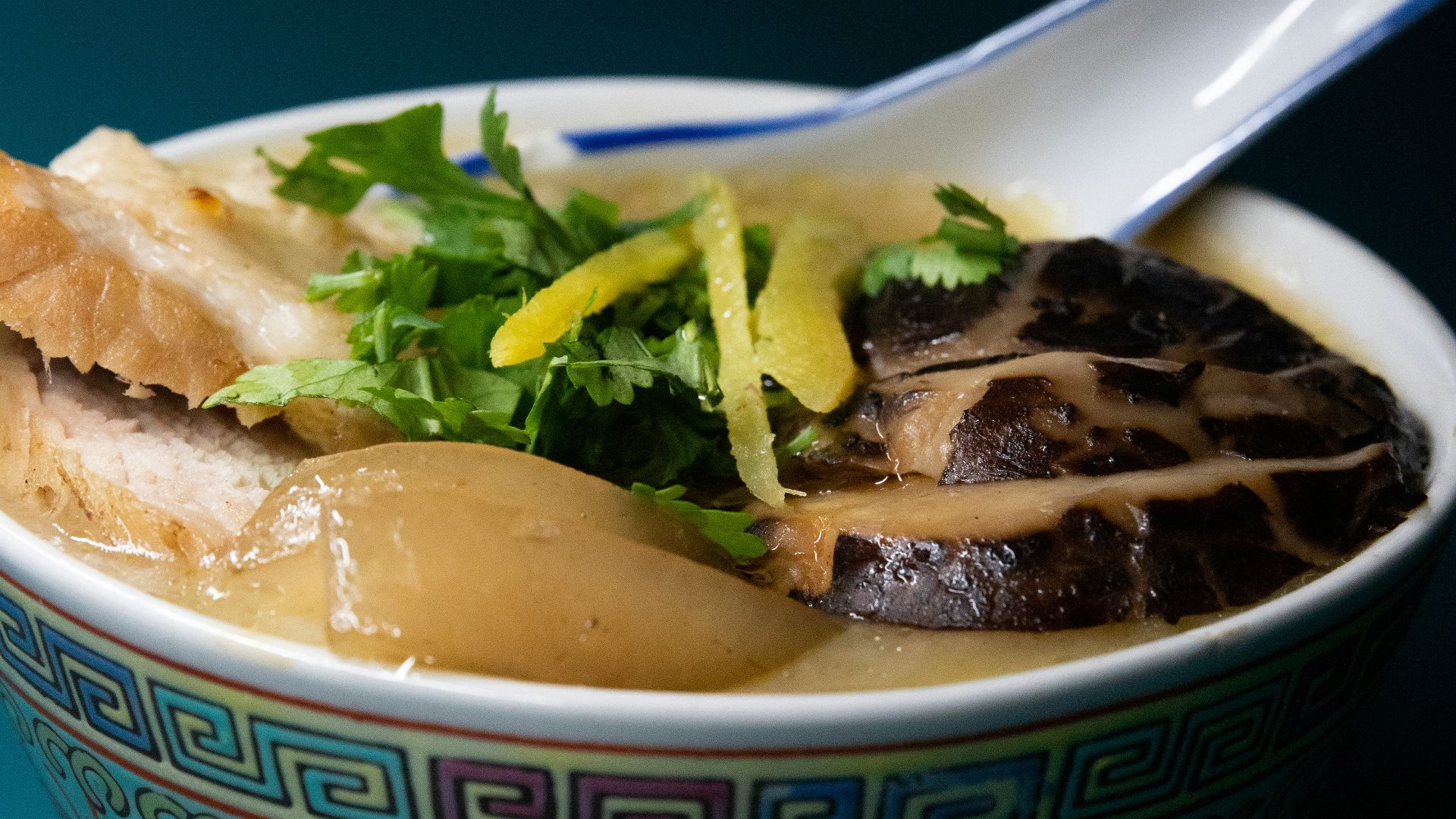 white and blue ceramic bowl with soup