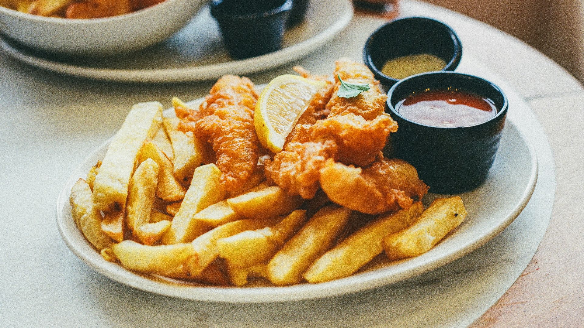 a white plate topped with fries and dipping sauce