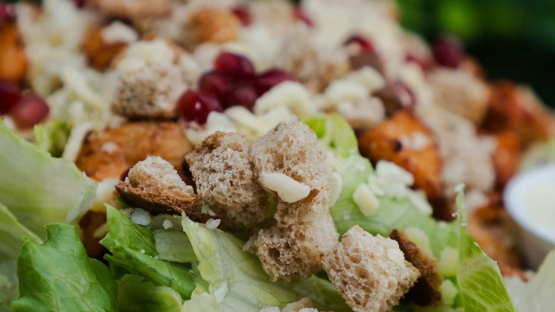 Chicken salad with croutons and pomegranate seeds