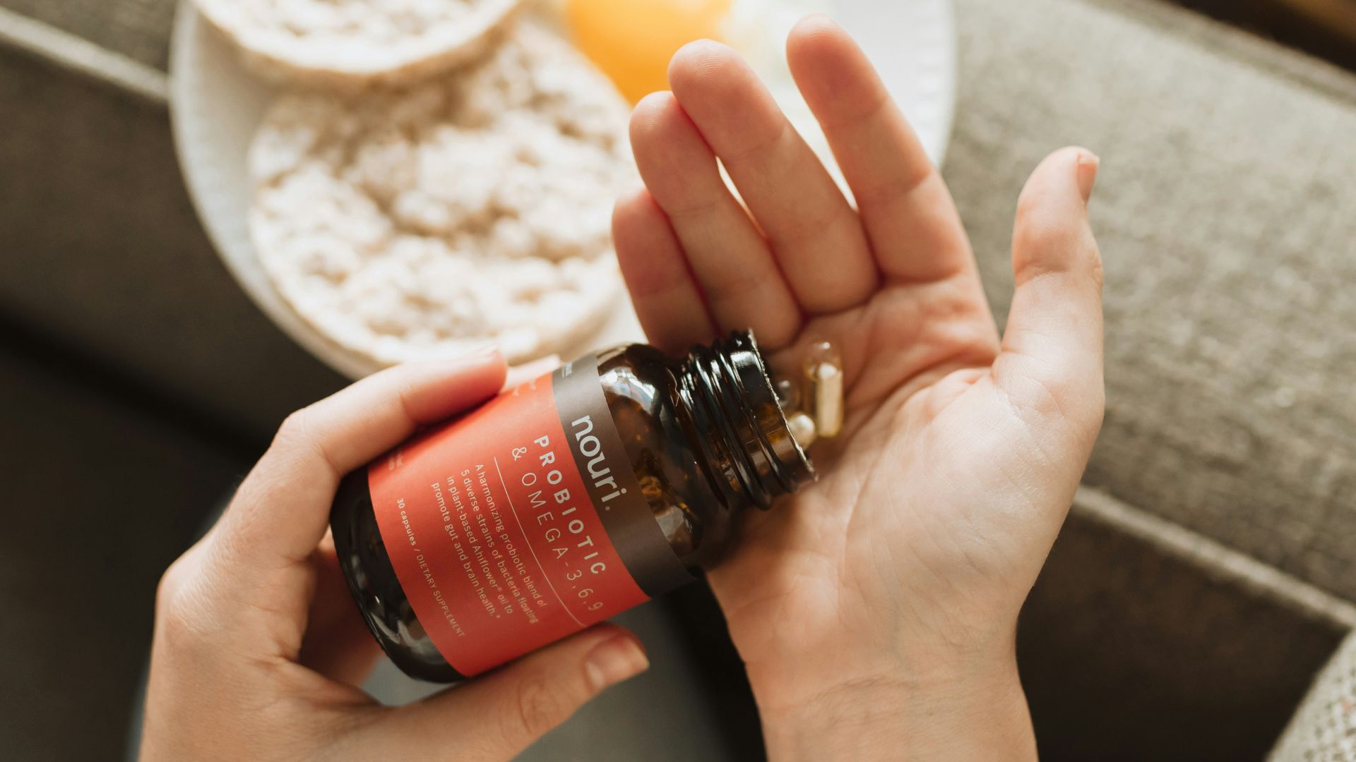 person holding red bottle