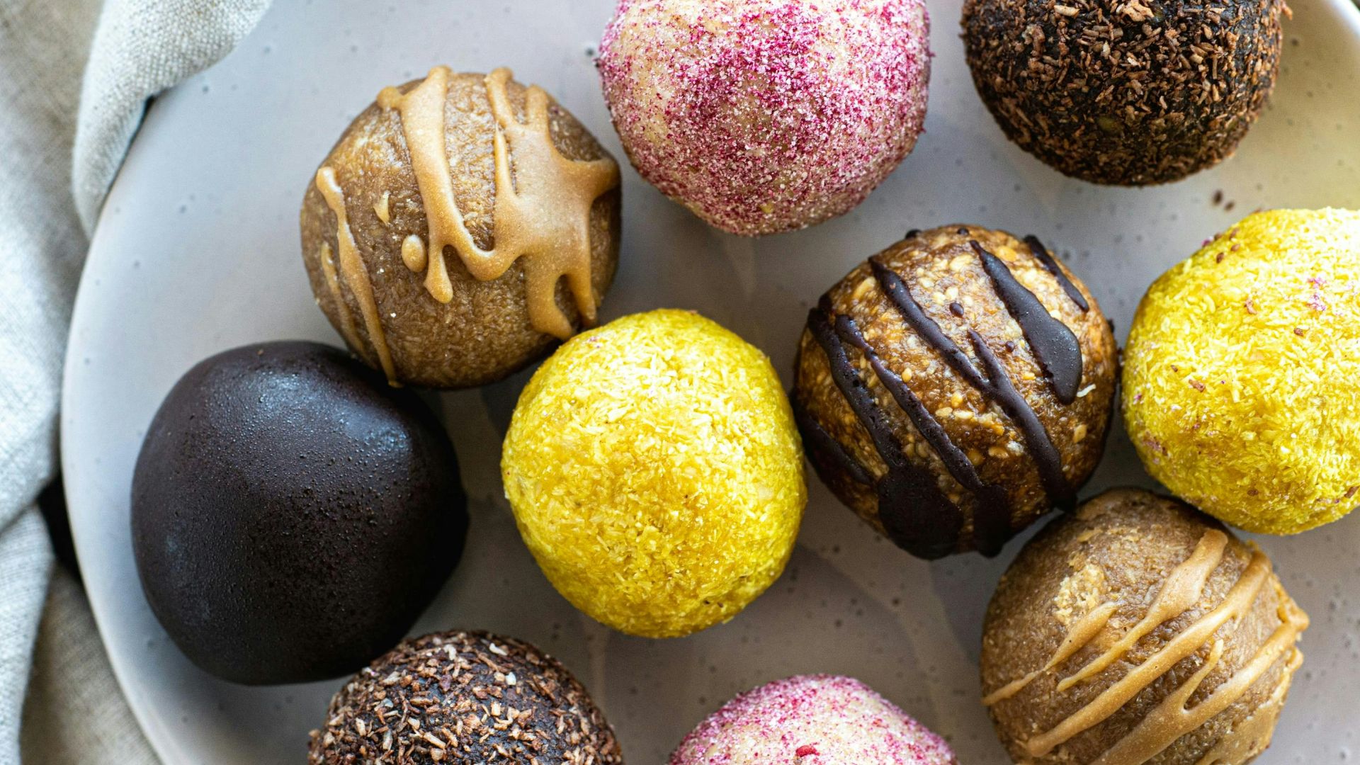 A white plate topped with different types of chocolates