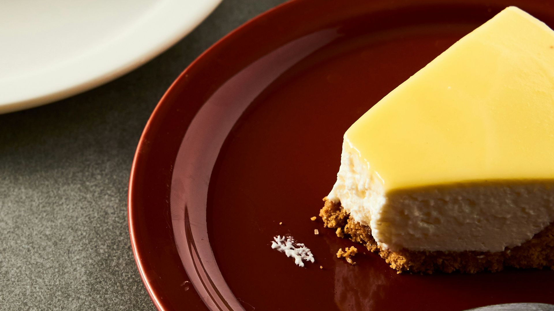 a slice of cheesecake on a plate with a fork