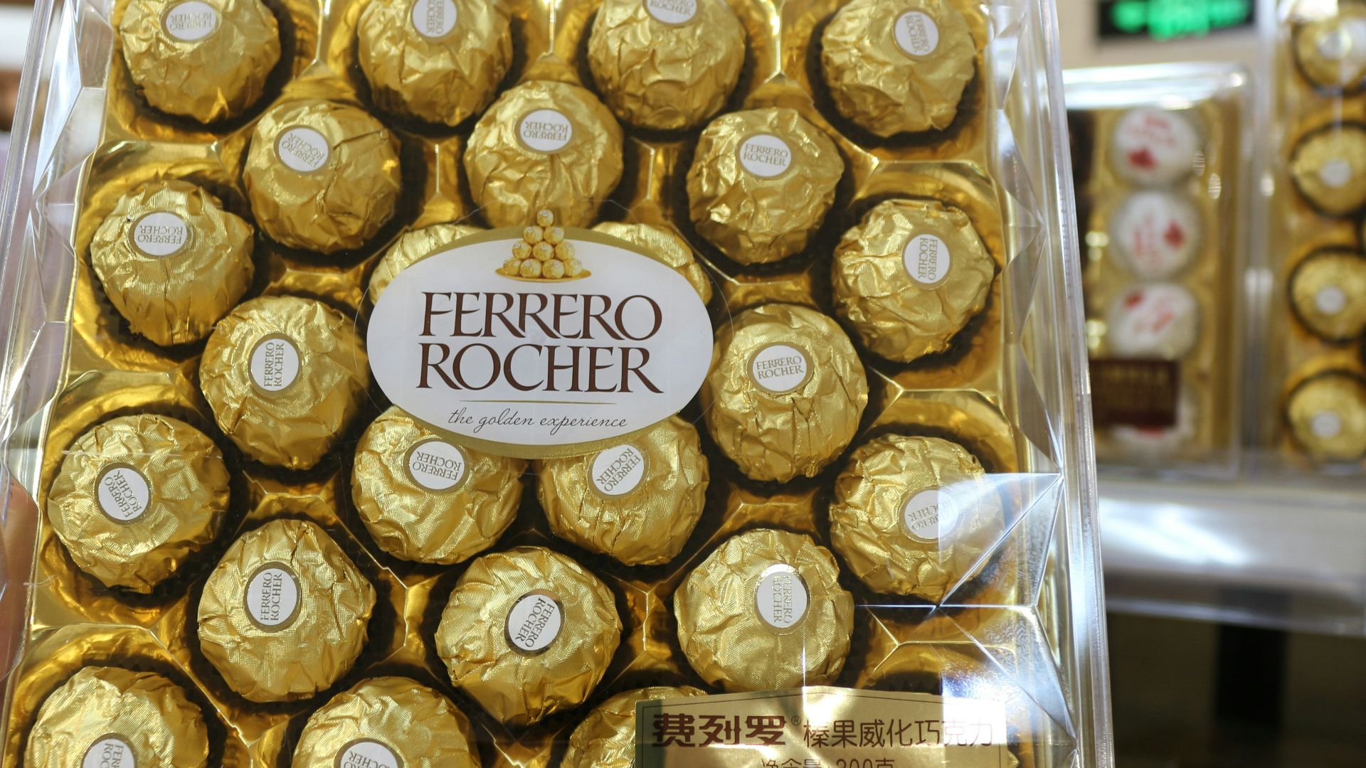 a person holding a box of chocolates in a store