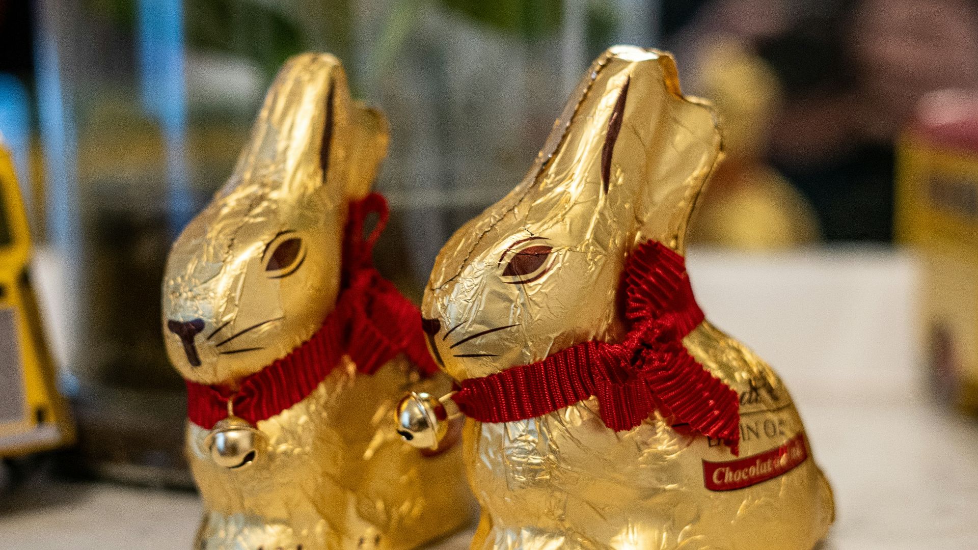 a couple of gold rabbits sitting on top of a table