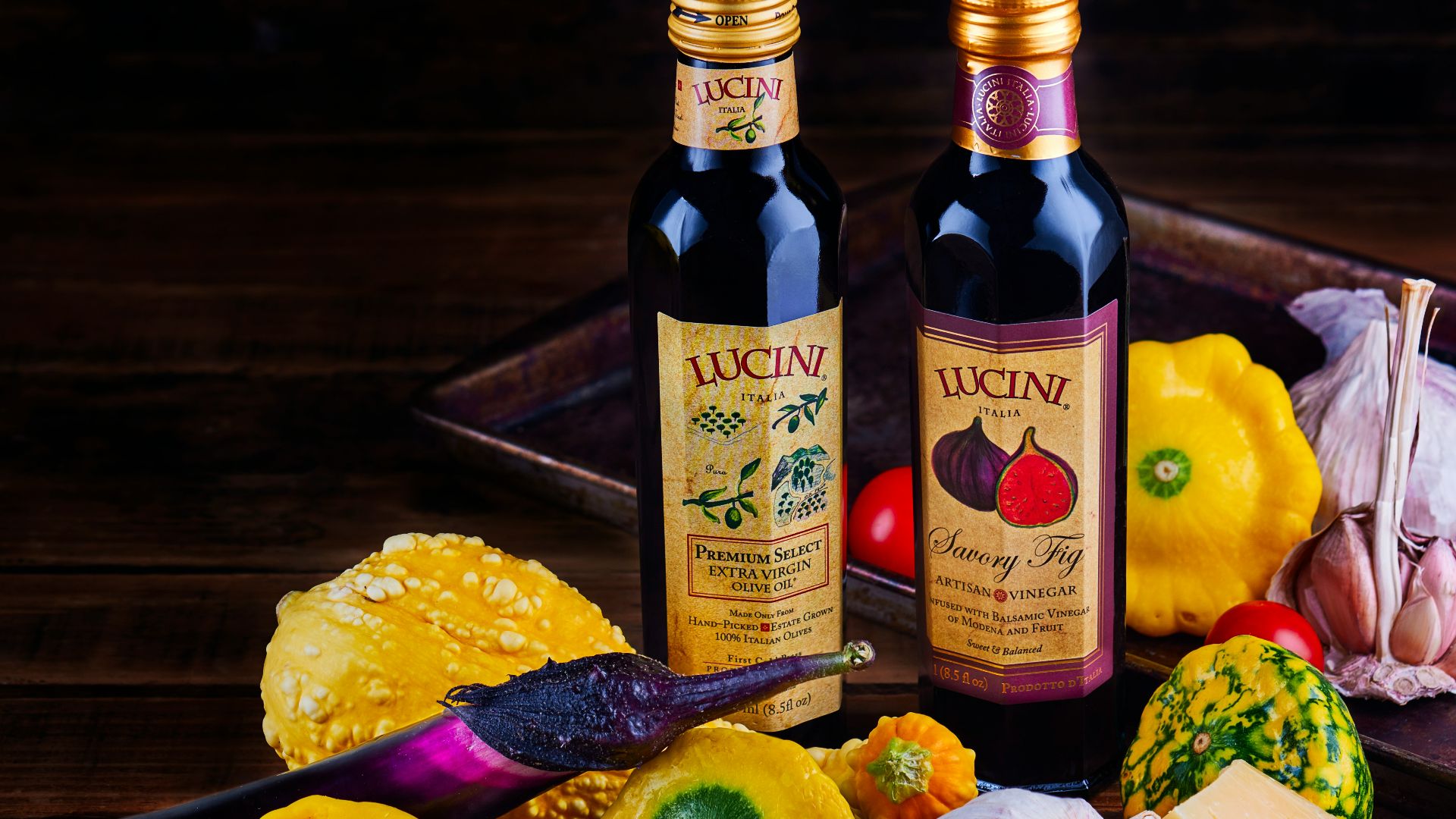 yellow labeled bottle beside red apple and yellow lemon fruit