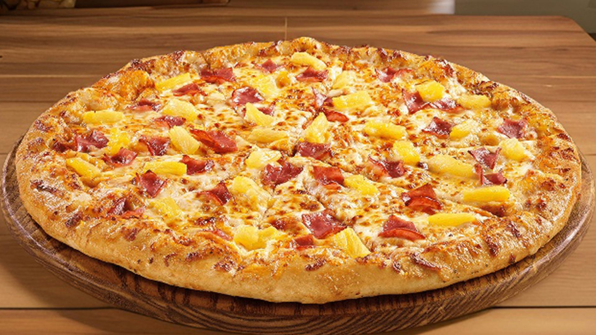 a large pizza sitting on top of a wooden table