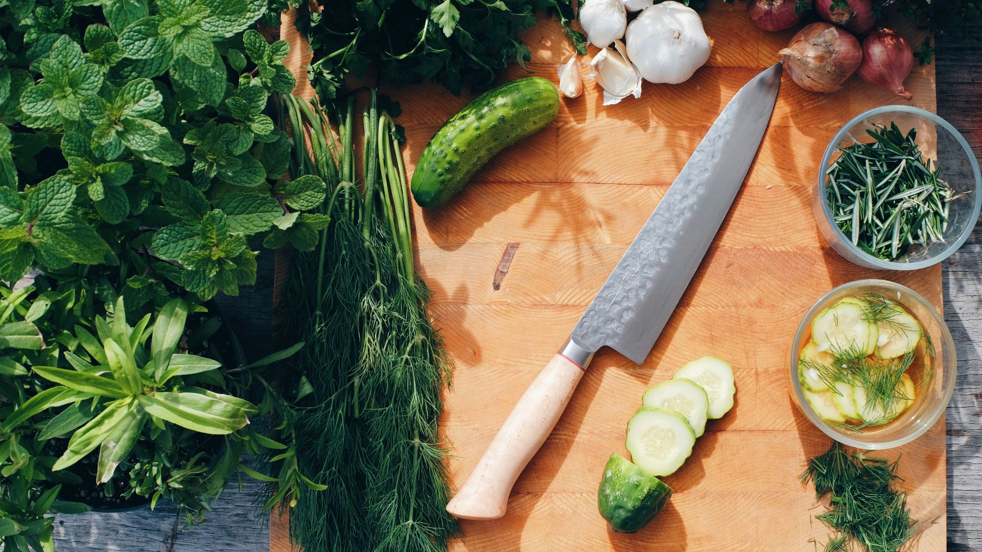 sliced cucumber and green vegetable on brown wooden chopping board