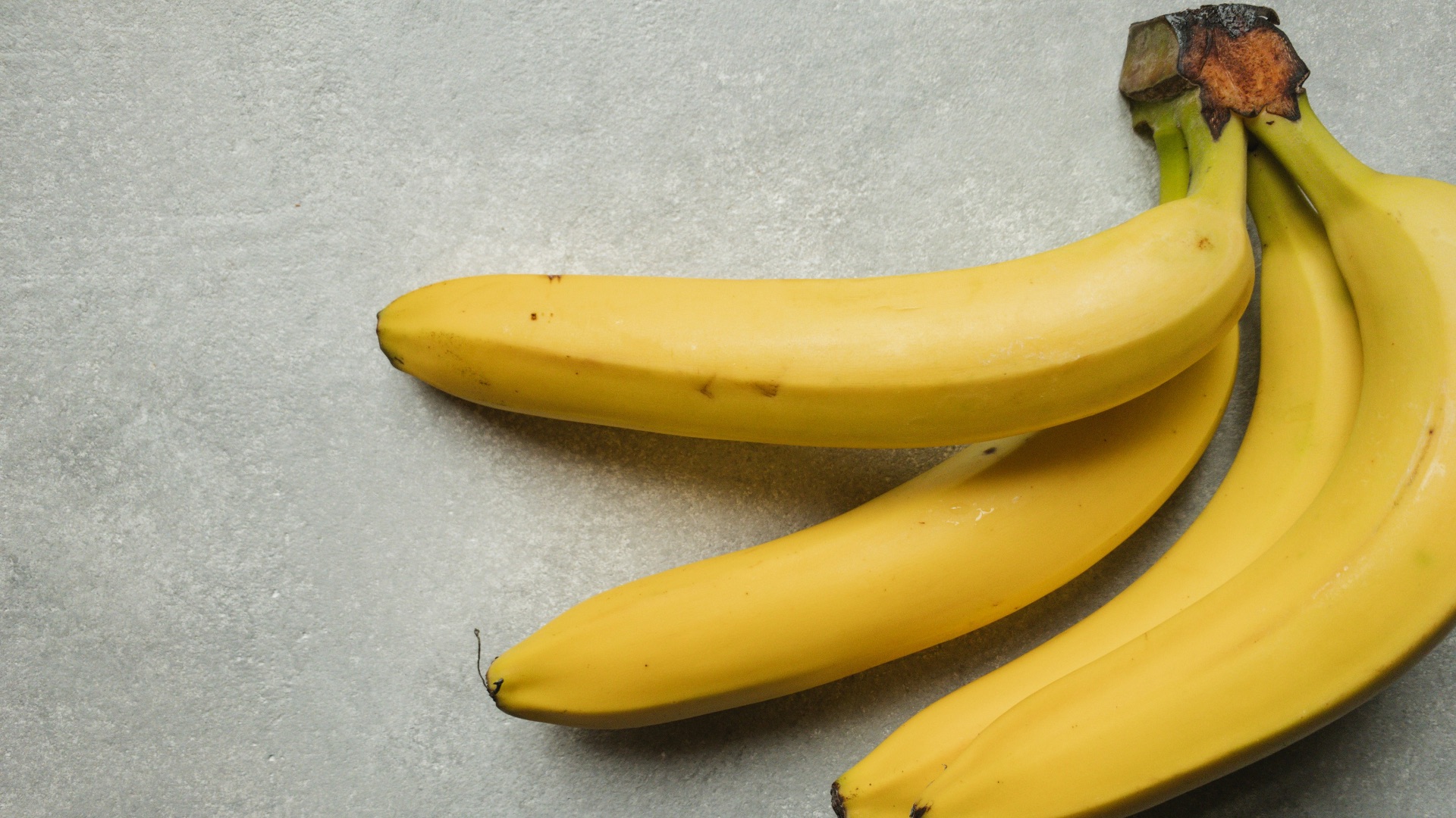 yellow banana fruit on gray table