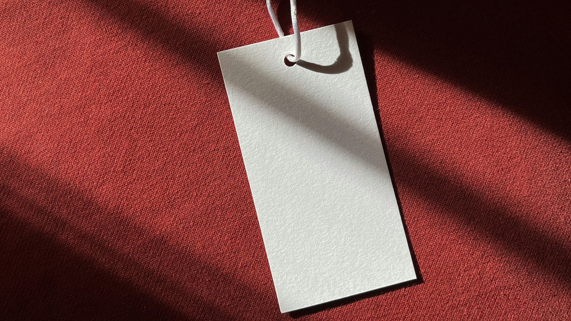 a red cloth with a white tag hanging from it