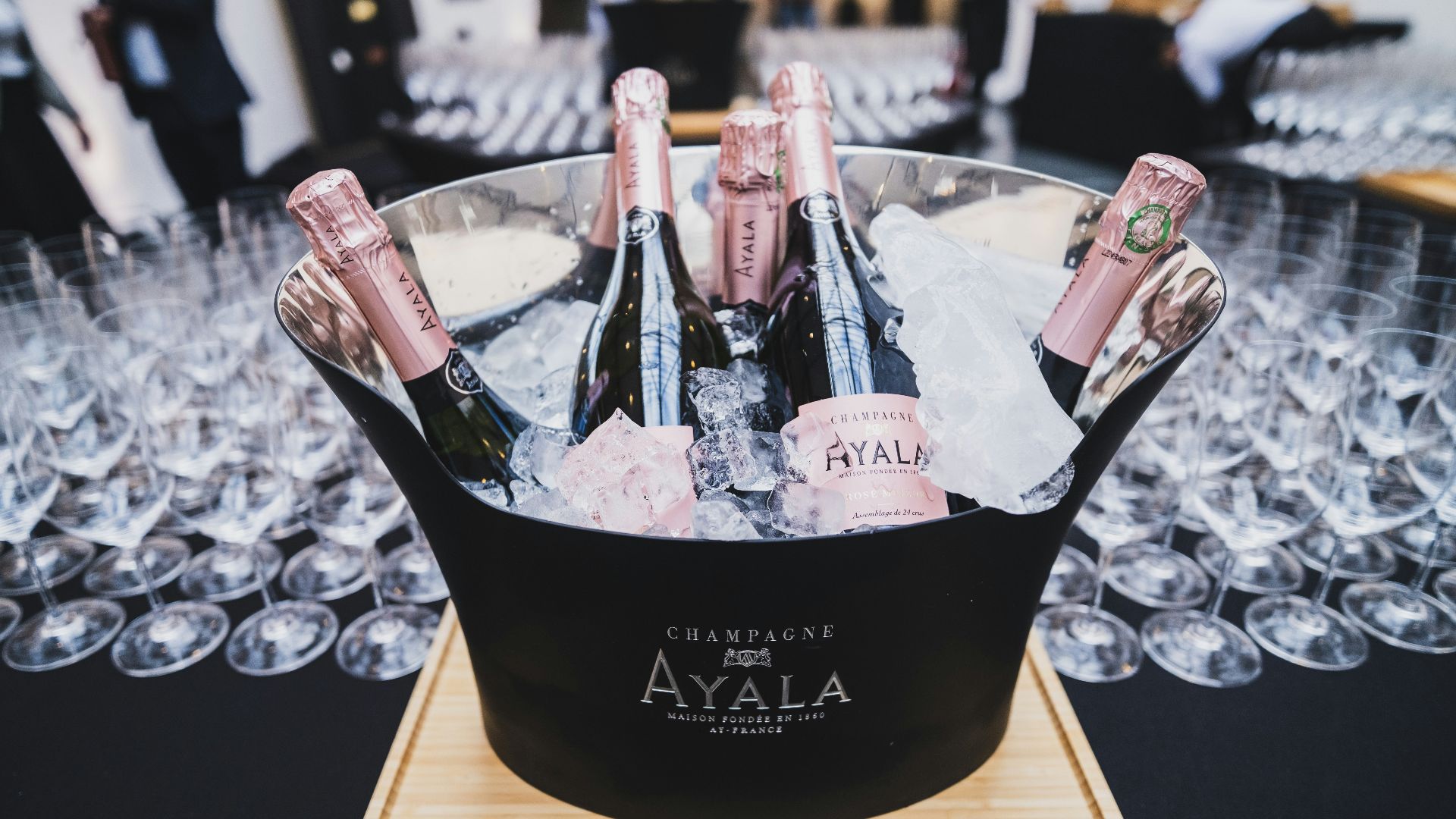 a bucket filled with bottles of champagne on top of a table