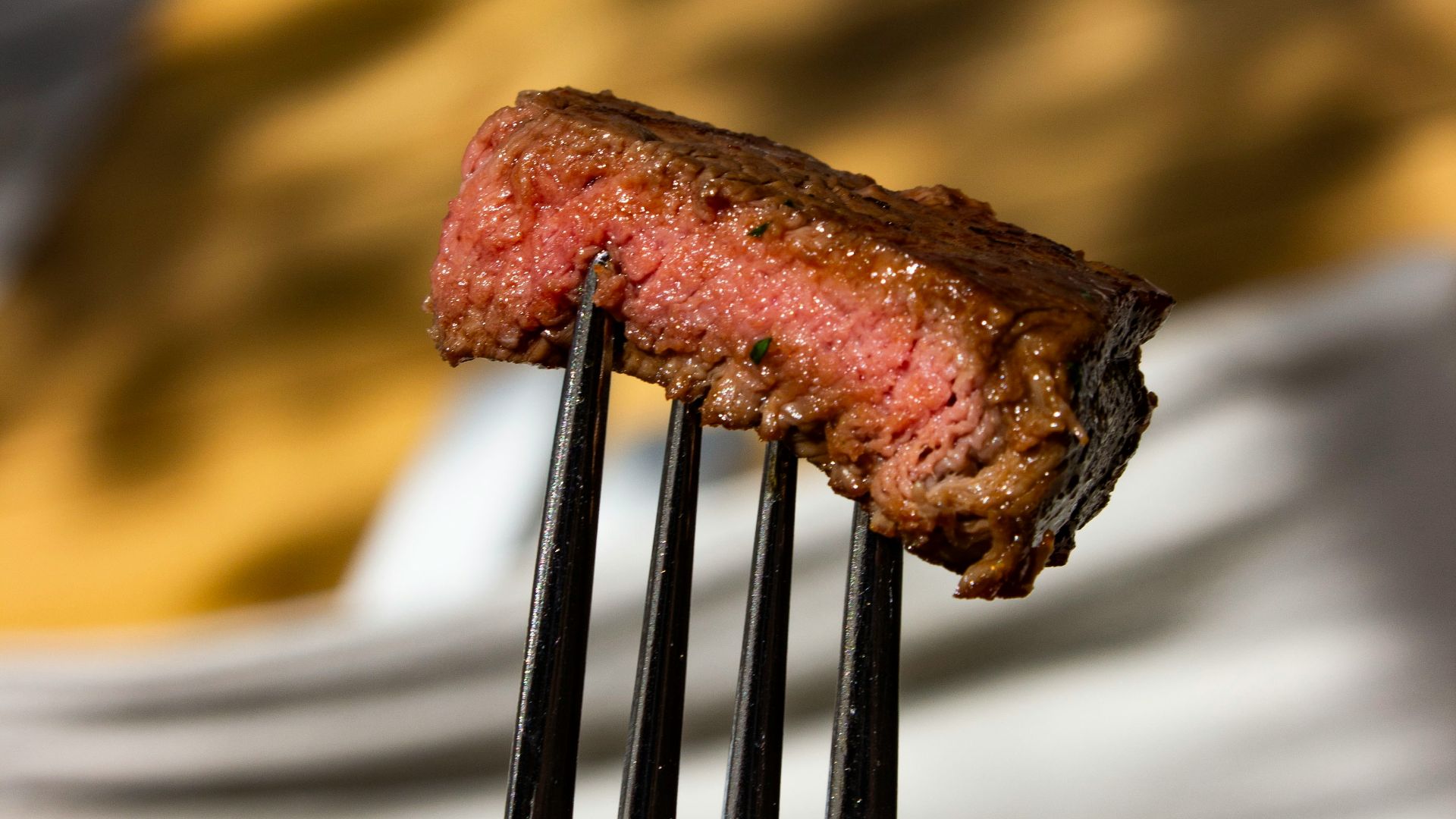 a fork with a piece of meat on it