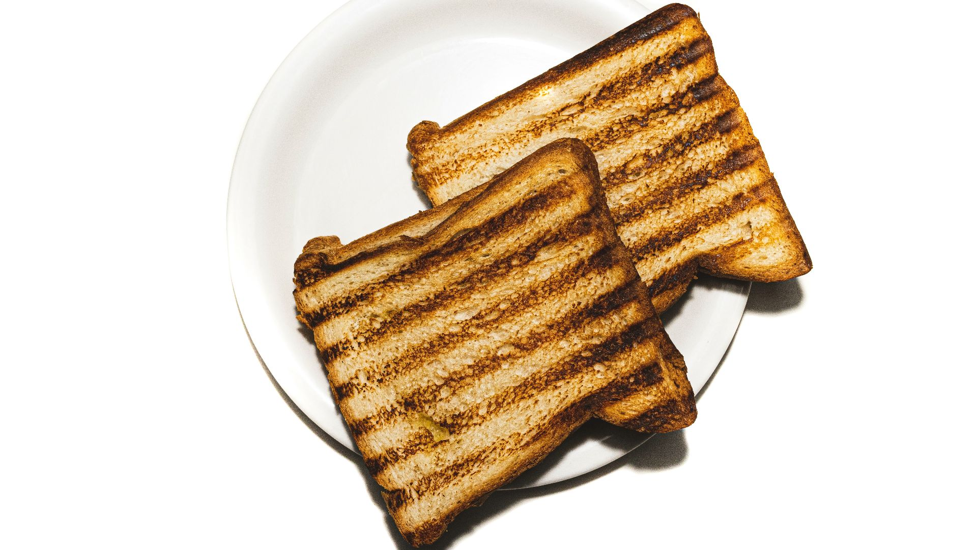 brown and black bread on white ceramic plate