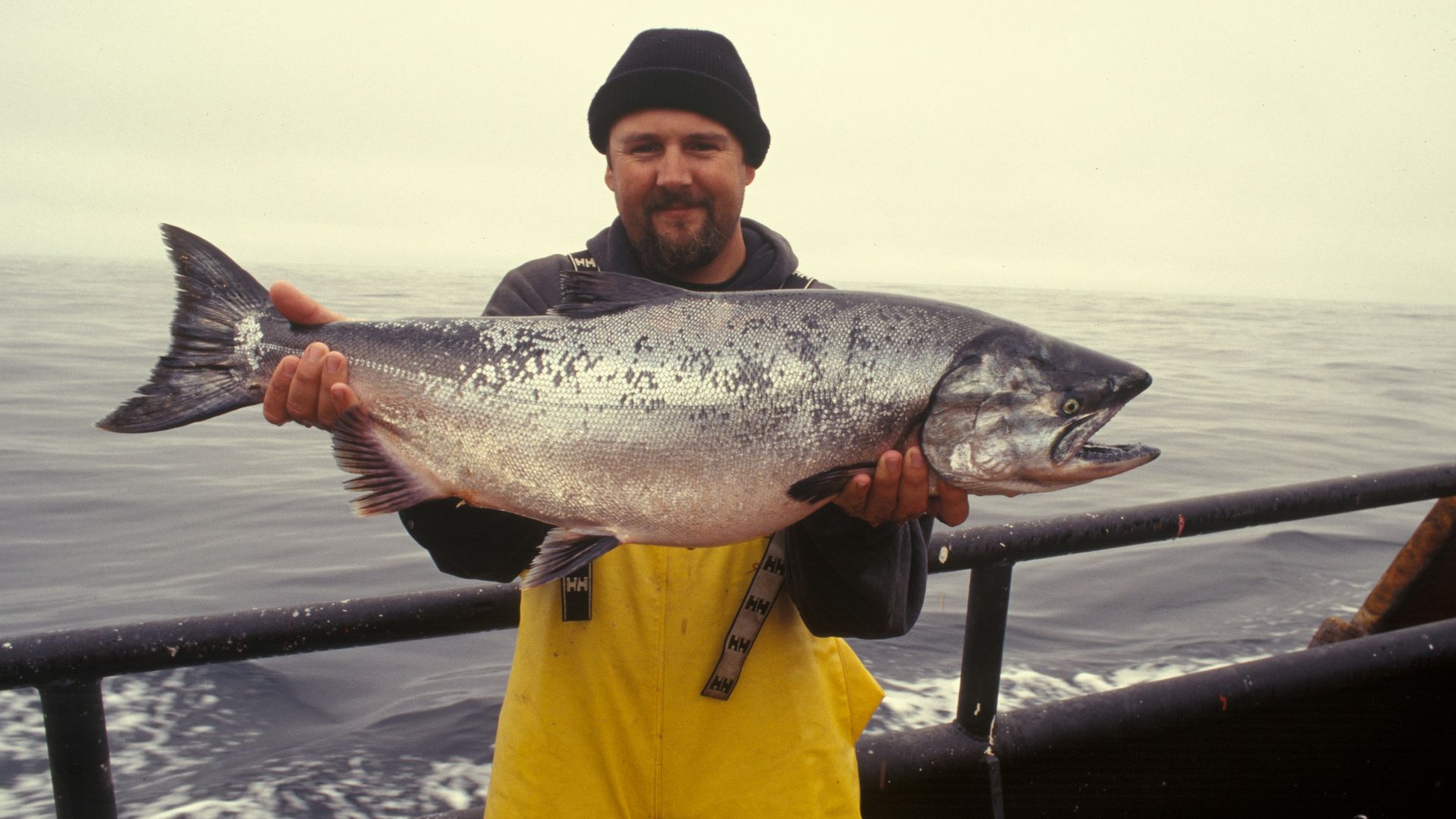 man carrying silver fish