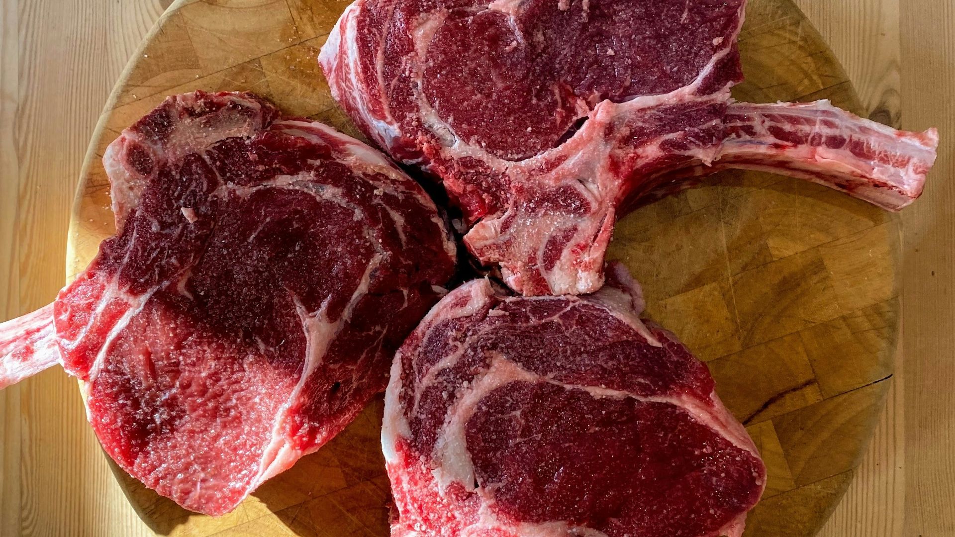 raw meat on brown wooden chopping board