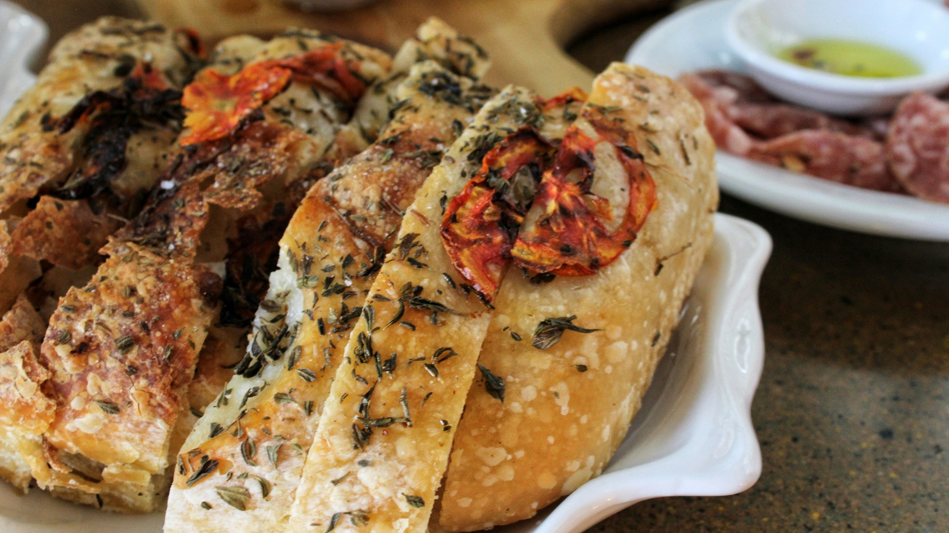 a white plate topped with bread covered in toppings