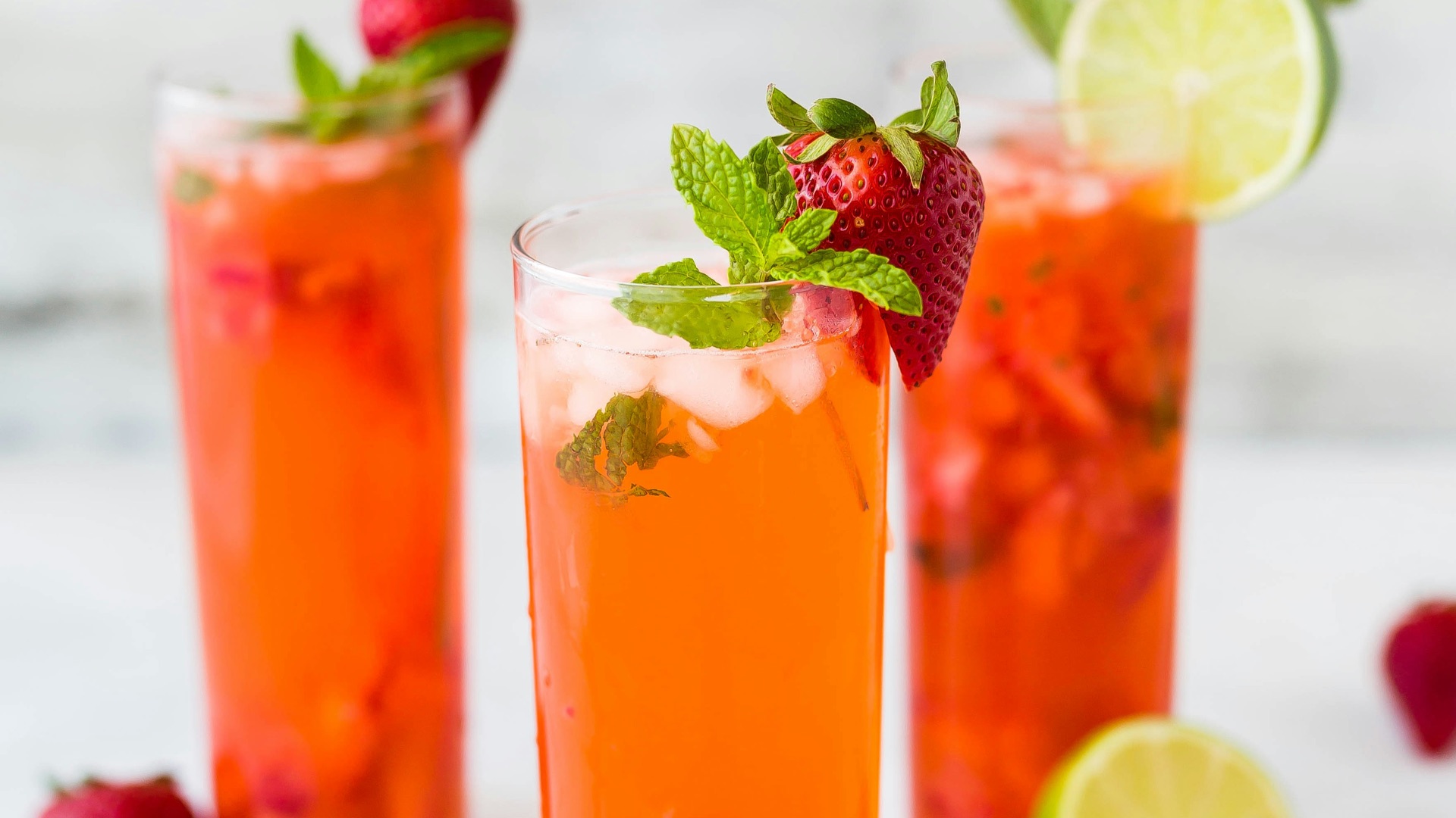 three clear drinking glasses filled with juice
