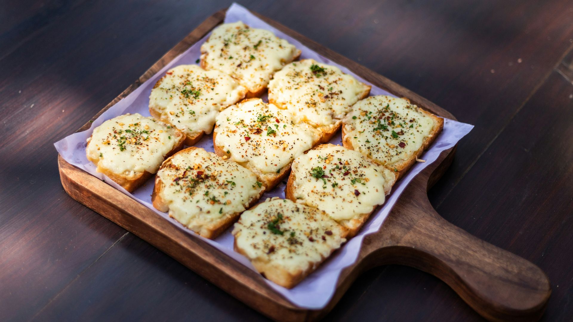 brown and white bread on brown wooden tray