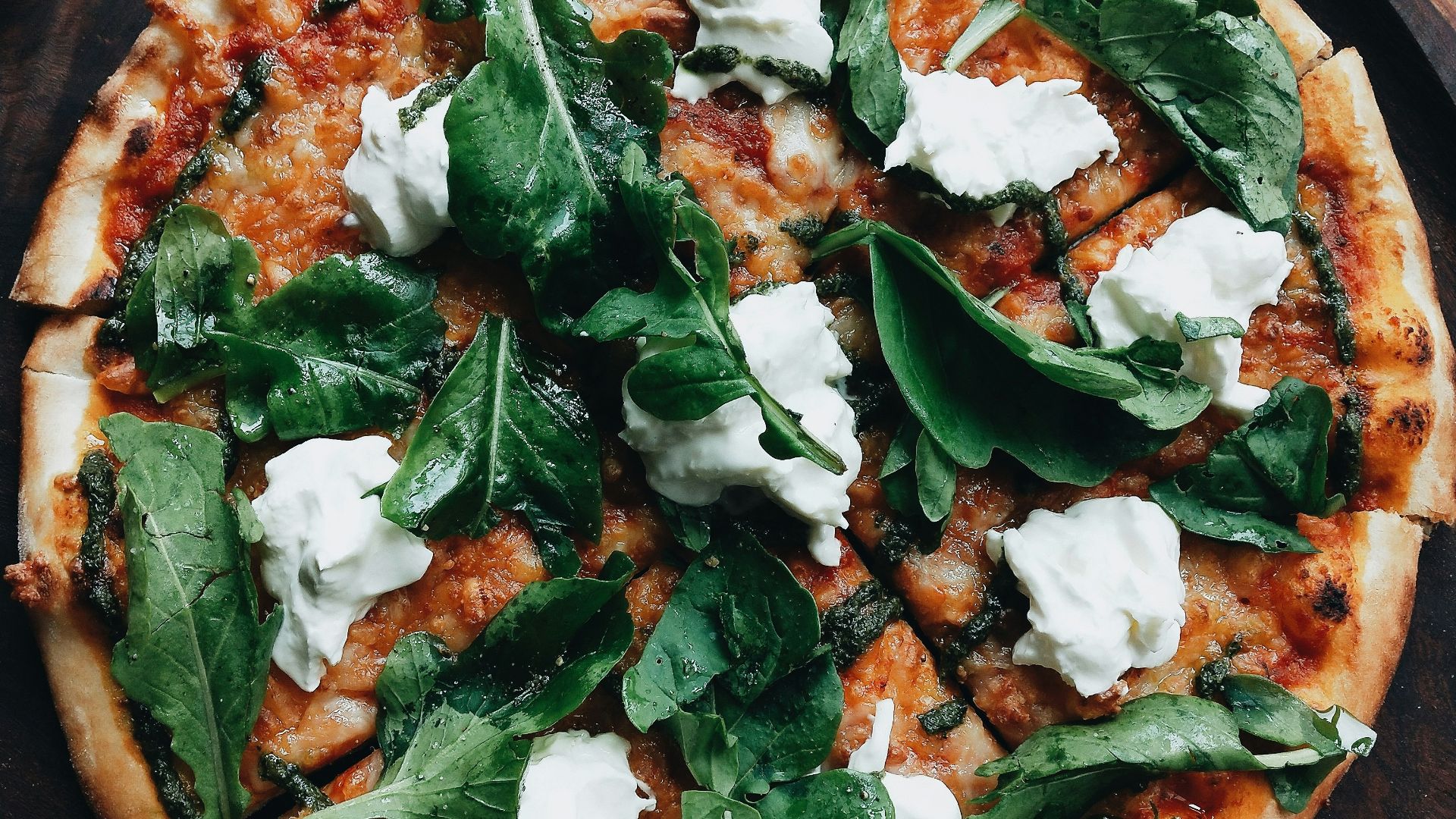 pizza with green leaves on top