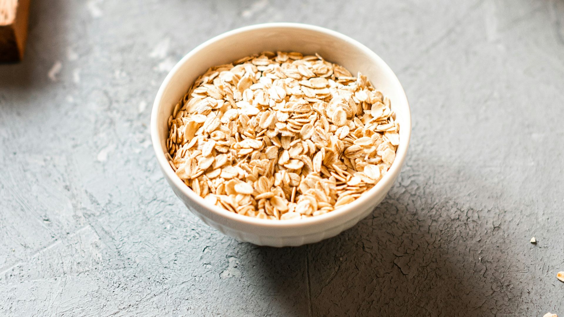 white ceramic bowl on brown wooden table